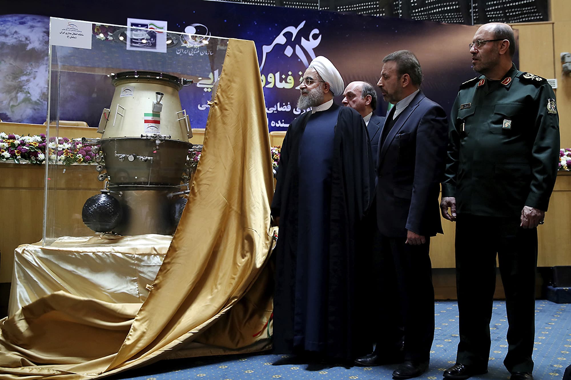 President Hassan Rouhani, left, visits an exhibition of Iran's latest achievements of space technology, in Tehran, 1 February 2017; he is accompanied by ICT Minister Mahmoud Vaezi and Defense Minister Hossein Dehghan, Iranian Presidency Office via AP