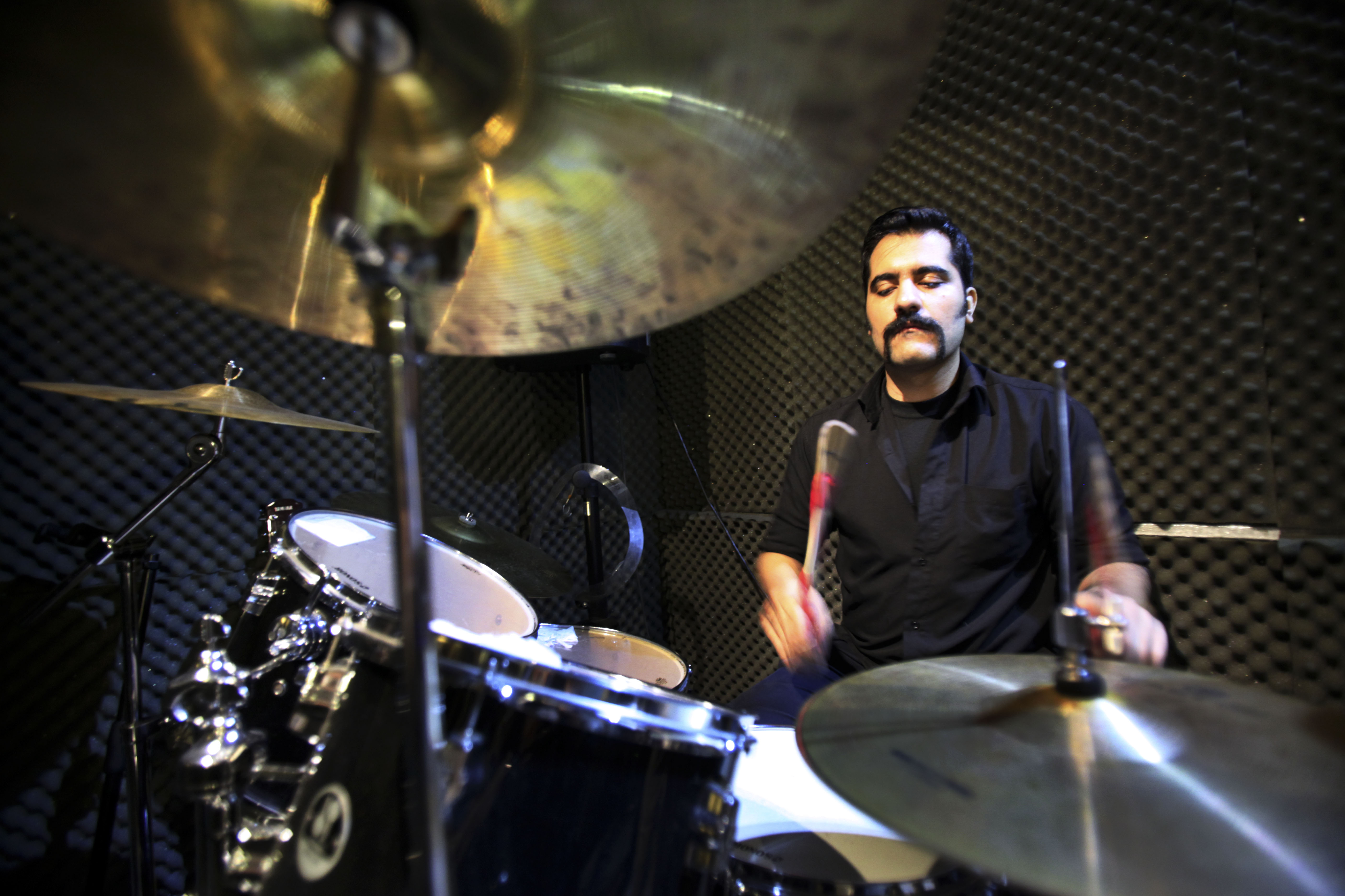 Iranian musician Ardeshir Jofreh, a member of a band called "Accolade," performs in an unauthorized stage performance in Tehran, Iran (25 January 2013), AP Photo/Vahid Salemi