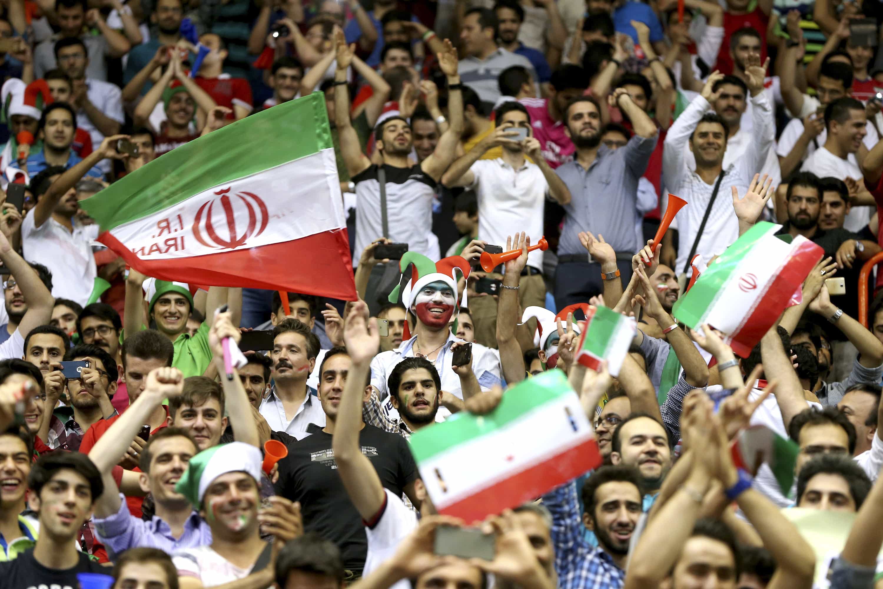 Spectators cheer Iran's national volleyball team playing the United States during their Men's Volleyball World League match at the Azadi (Freedom) Stadium in Tehran on 21 June 2015, AP Photo/Ebrahim Noroozi