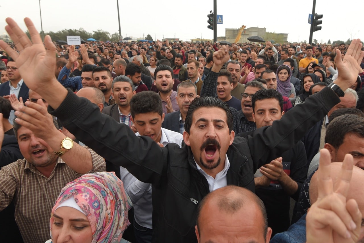 Civil servants working for the Iraqi Kurdish Regional Government (IKRG) protest against the release of their delayed salaries with deductions, in Suleymaniyah, Iraq, 25 March 2018, Feriq Ferec/Anadolu Agency/Getty Images
