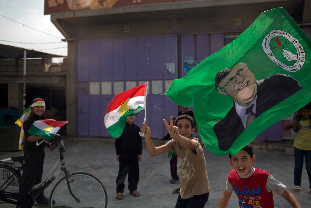 Children holding Kurdish flags run on the streets of the disputed city of Kirkuk, 25 September 2017, AP Photo/Bram Janssen