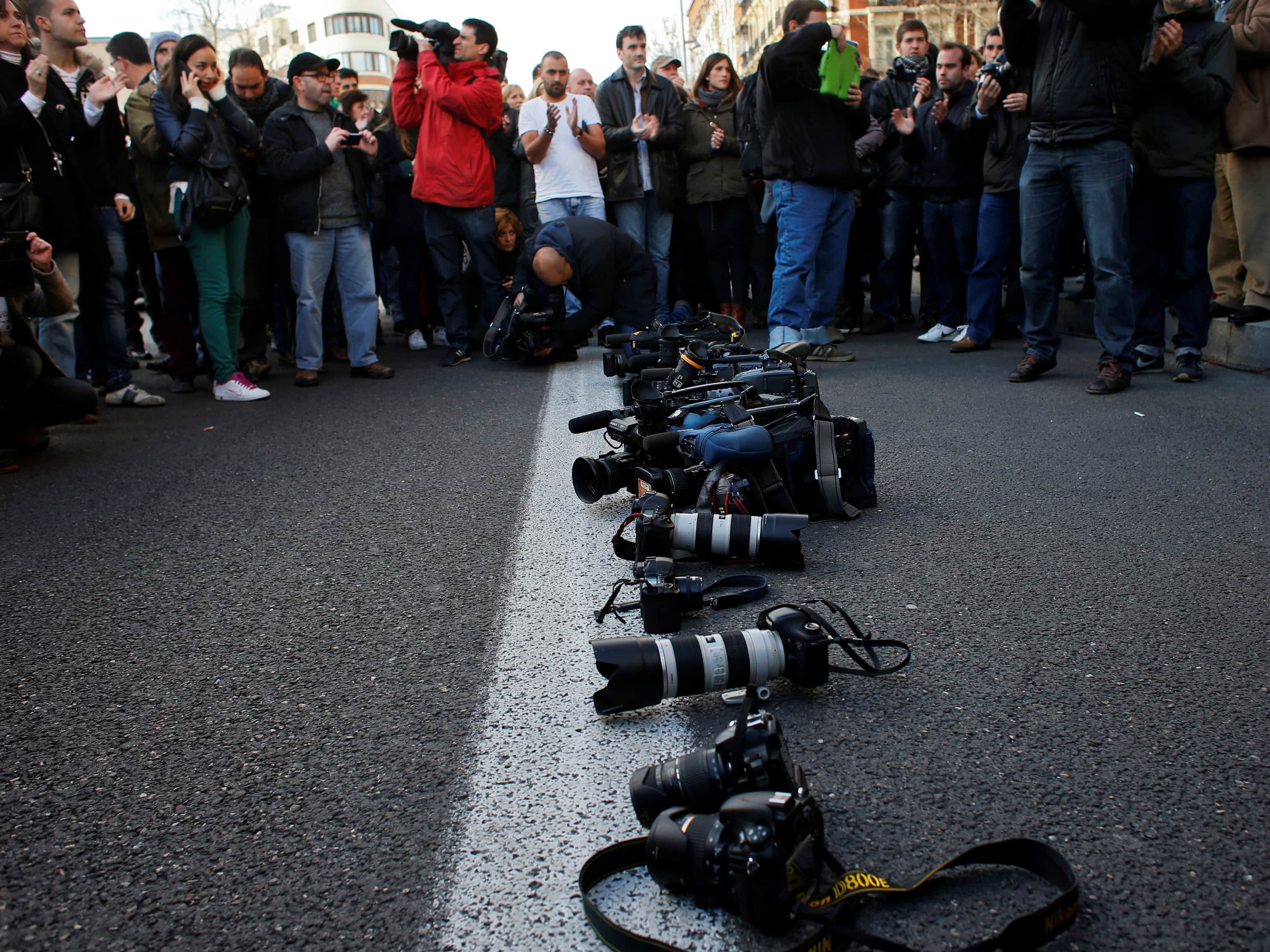 Spanish journalists and supporters stage a protest on the 10th anniversary of the death of cameraman Jose Couso in front of Madrid's U.S. embassy, 6 April 2013, REUTERS/Susana Vera
