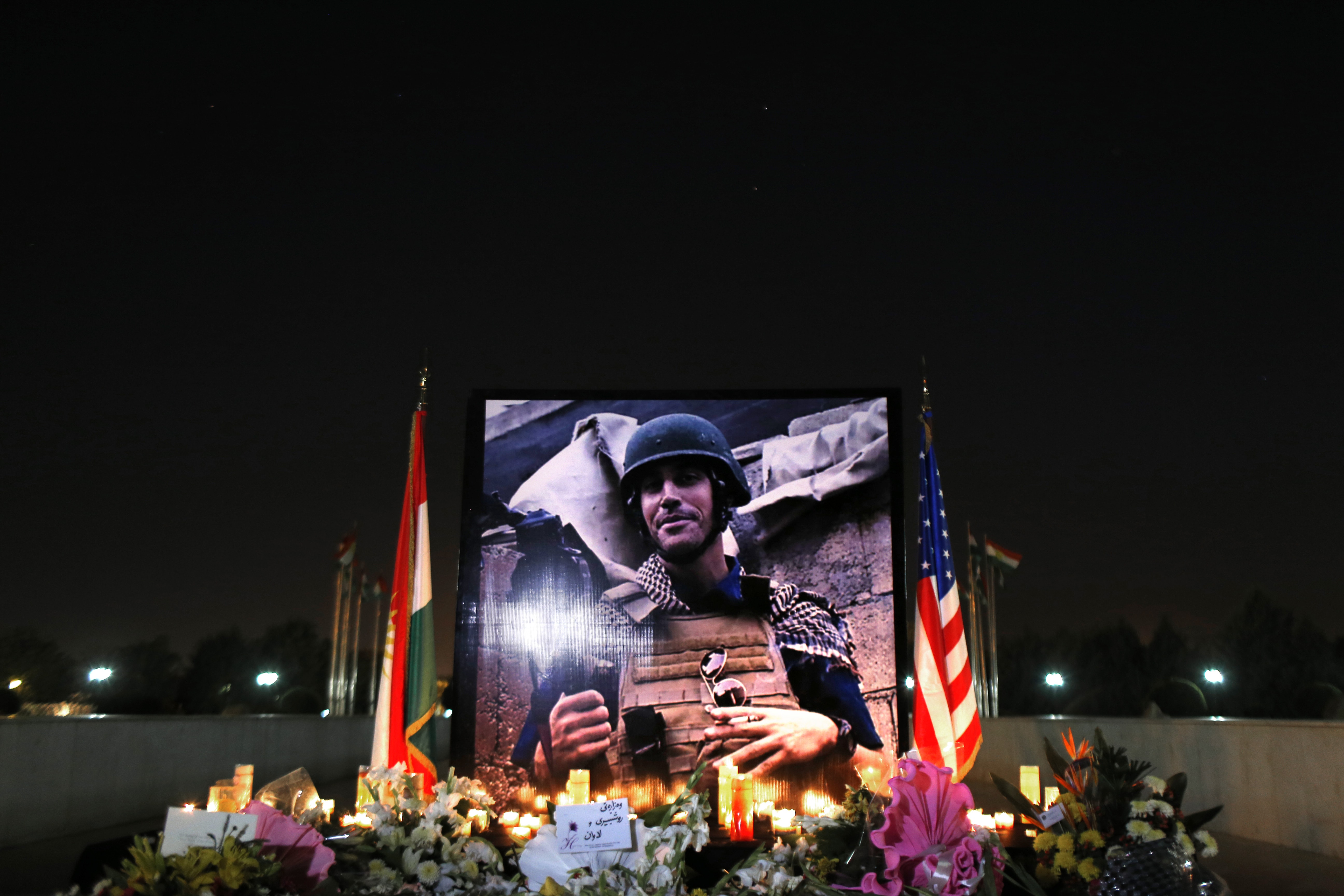 A photograph of James Foley is seen during a memorial service in Irbil, north of Baghdad, Iraq, on 24 August 2014, AP Photo/ Marko Drobnjakovic