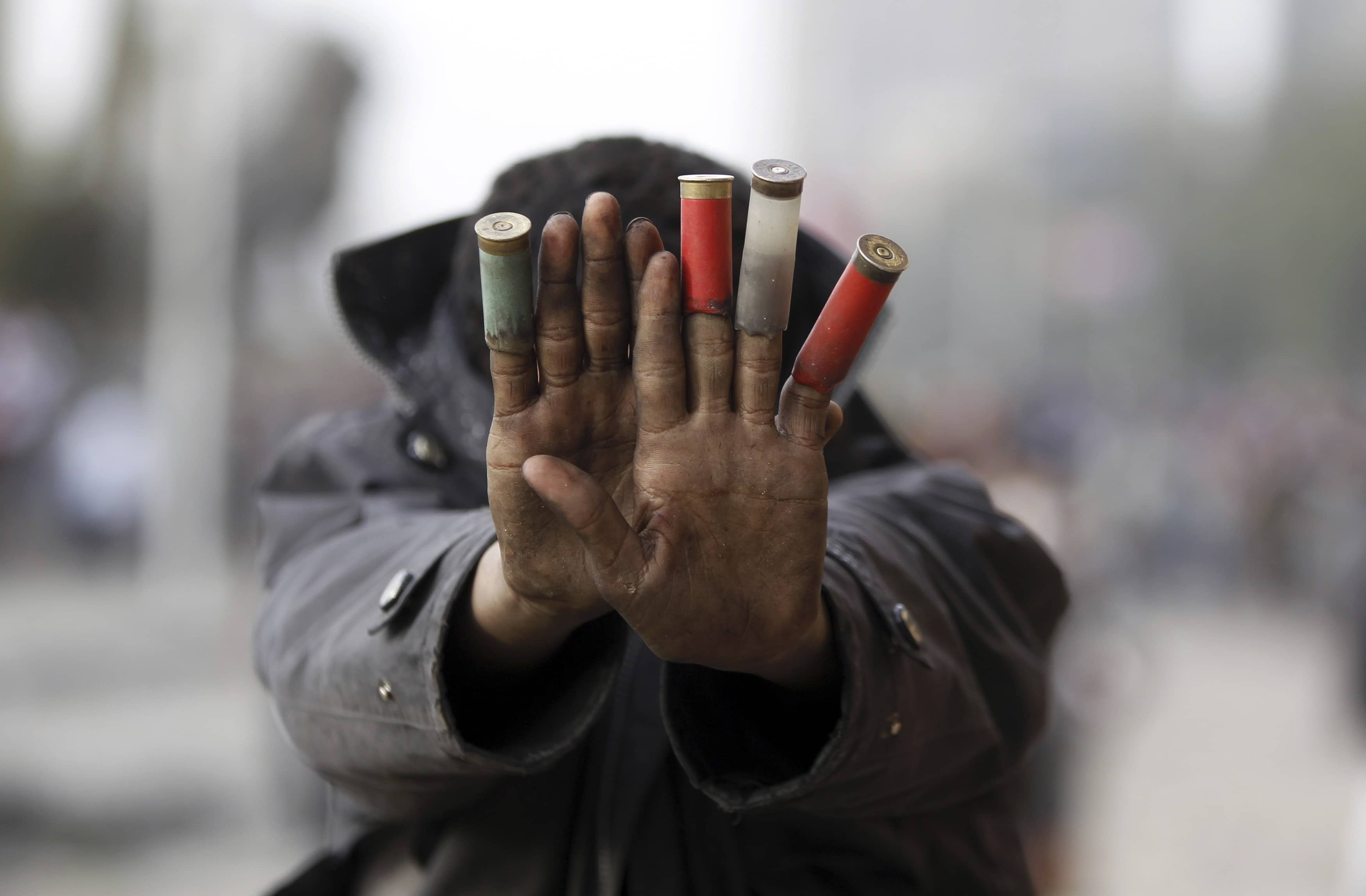 A protester opposing Egypt's President Mohamed Morsi shows expended shotgun cartridges that he said were fired by riot police during clashes along Qasr Al Nil bridge, which leads to Tahrir Square in Cairo January 27, 2013, REUTERS/Amr Abdallah Dalsh