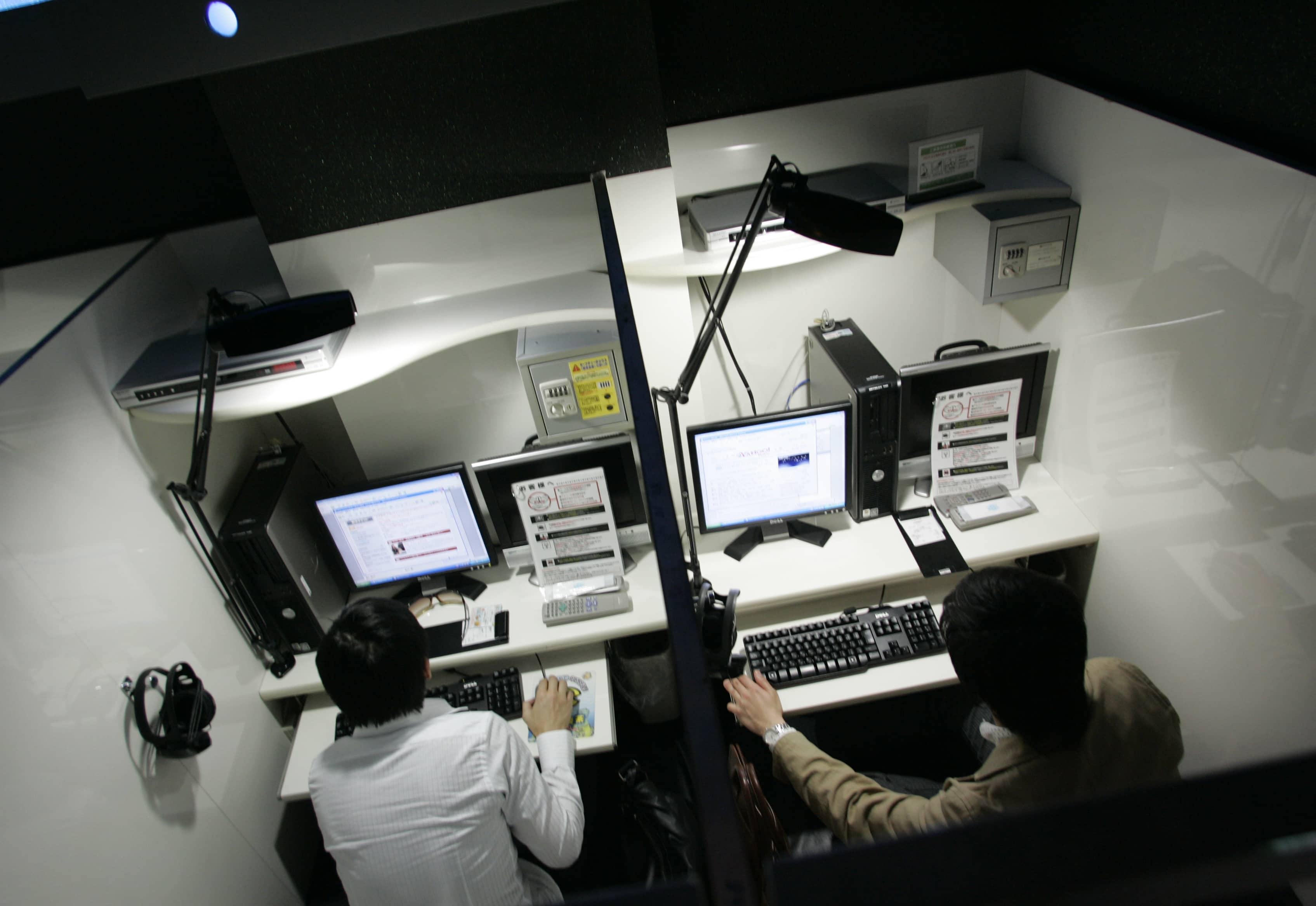 In this May 2007 file photo, men make use of the internet service in the private rooms of an internet cafe in Tokyo, REUTERS/Kim Kyung-Hoon