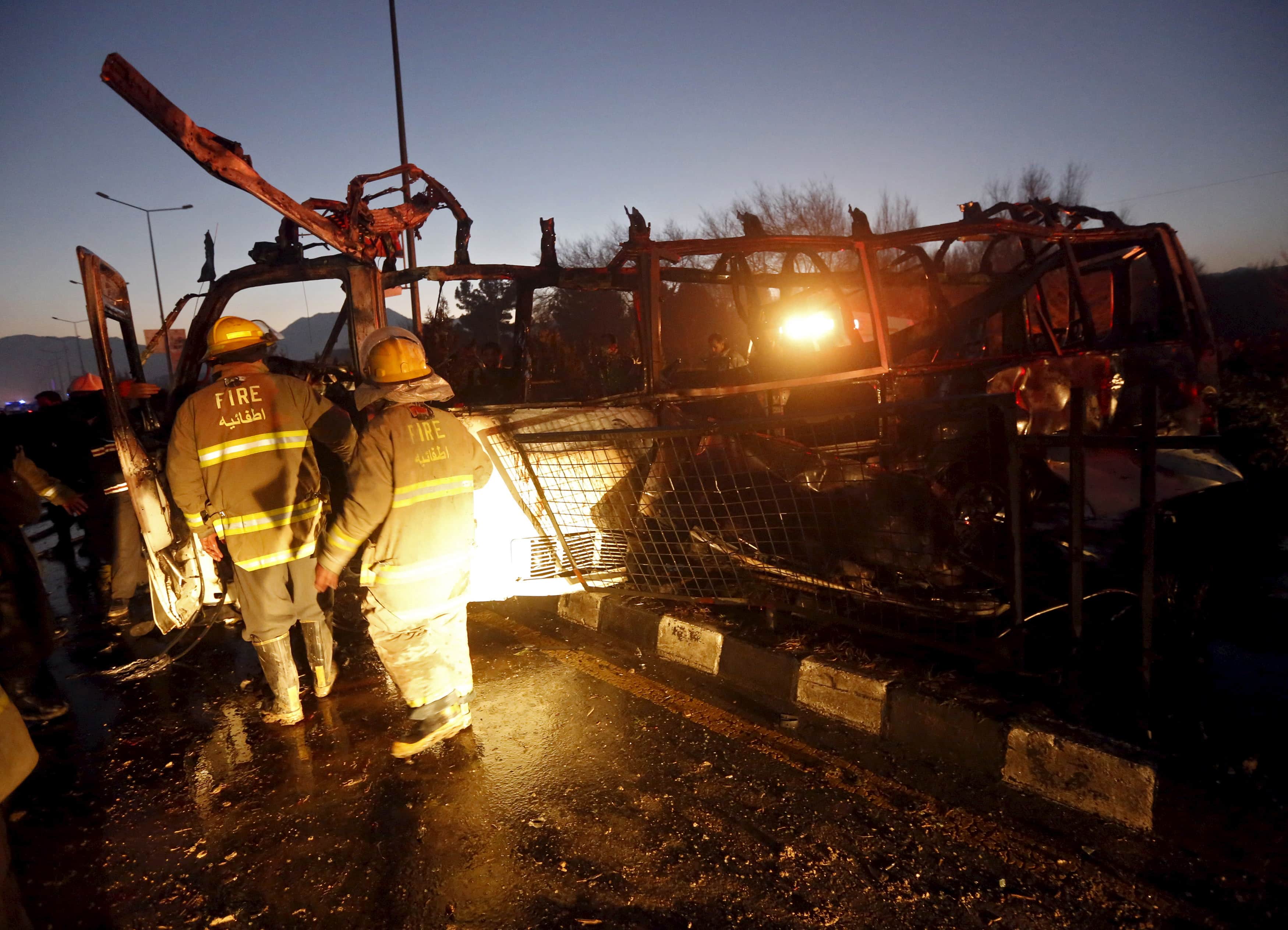 Fire-fighters inspect the wreckage of a bus was hit by a suicide bomb attack in Kabul, Afghanistan January 20, 2016, REUTERS/Omar Sobhani