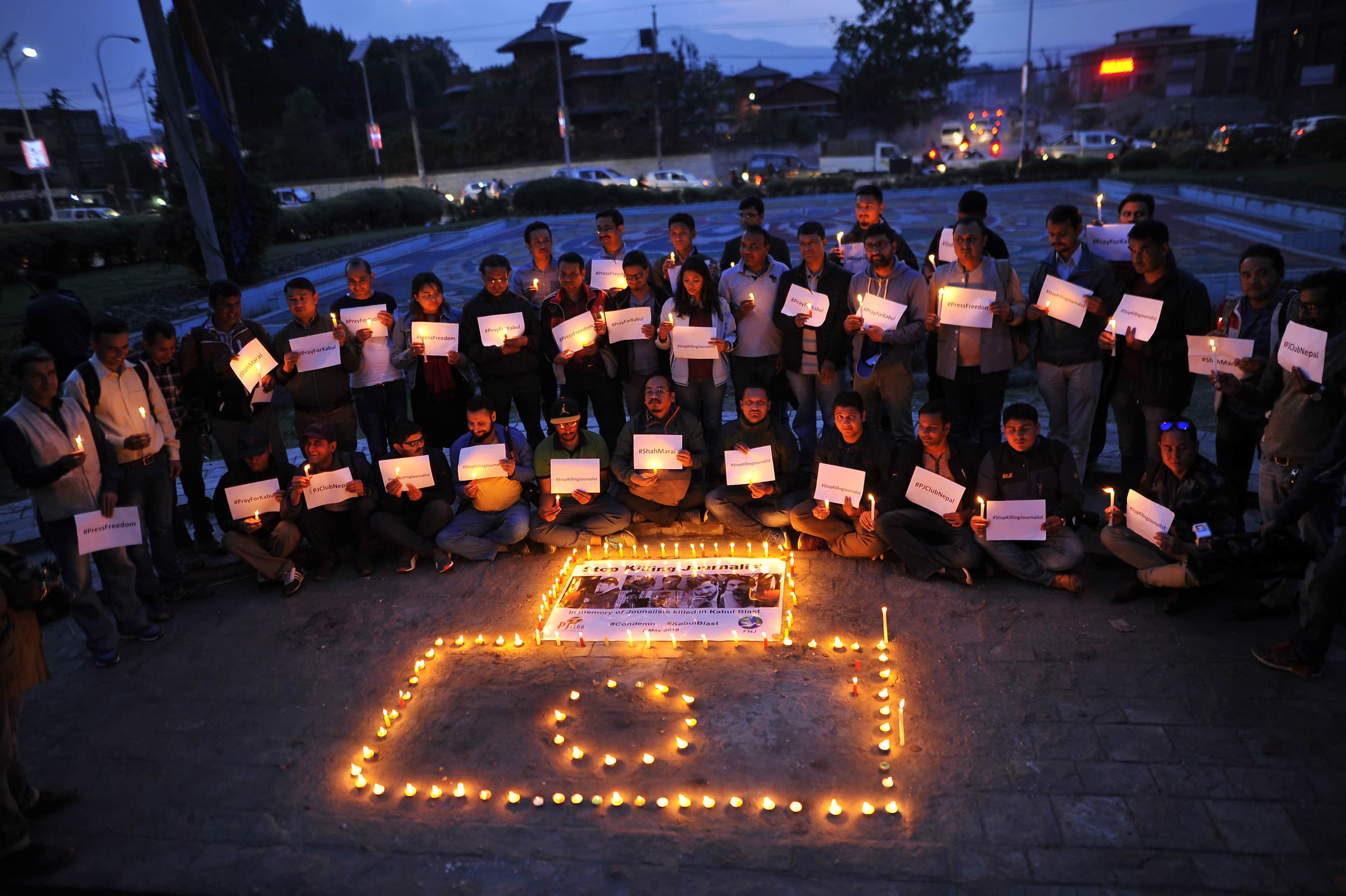 Nepali journalists and photojournalists lit candles to pay tribute to the journalists killed in Kabul attack, May 02, 2018, Narayan Maharjan/NurPhoto via Getty Images
