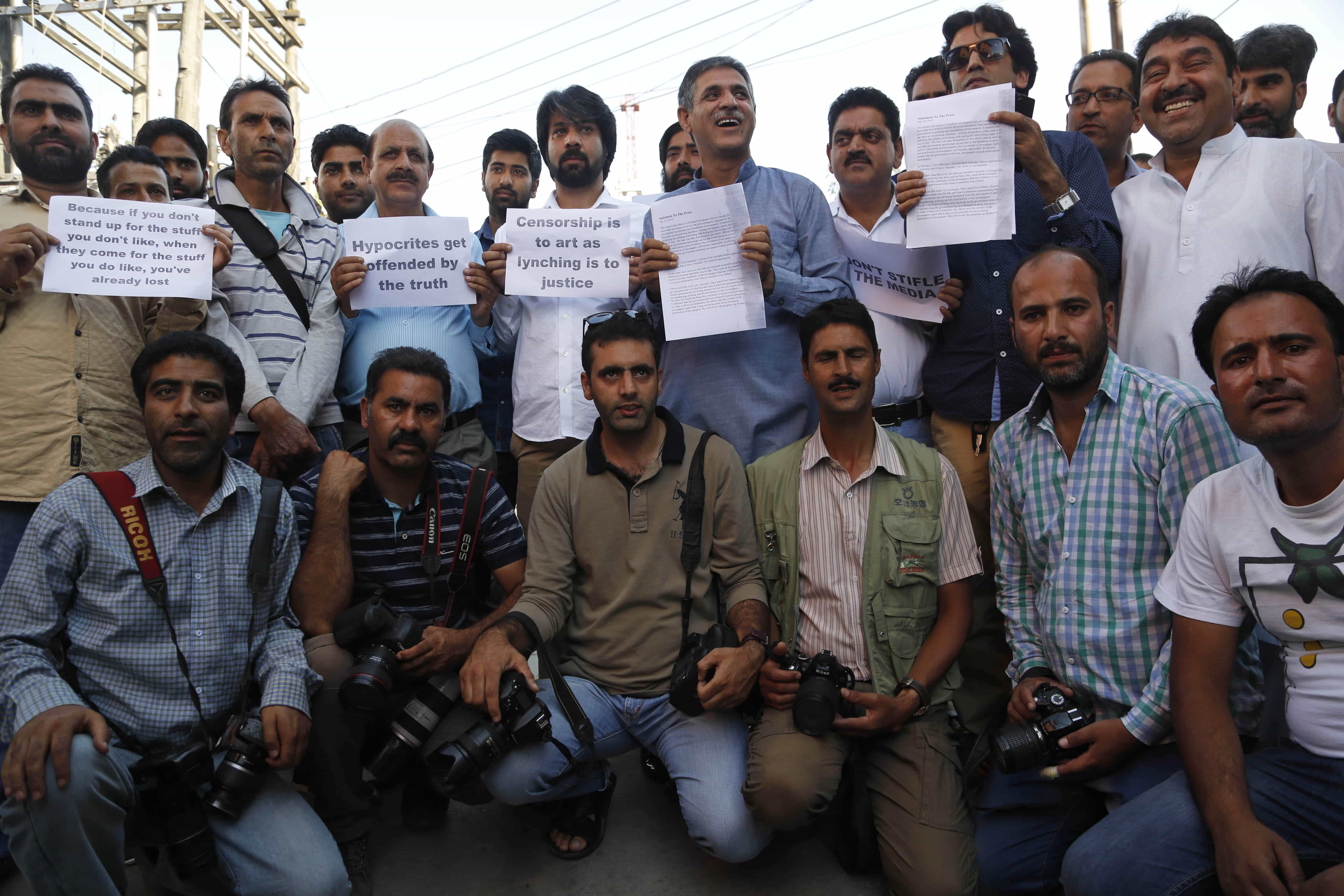 Local journalists hold placards during a protest in Srinagar, India, 19 July 2016, AP Photo/Mukhtar Khan