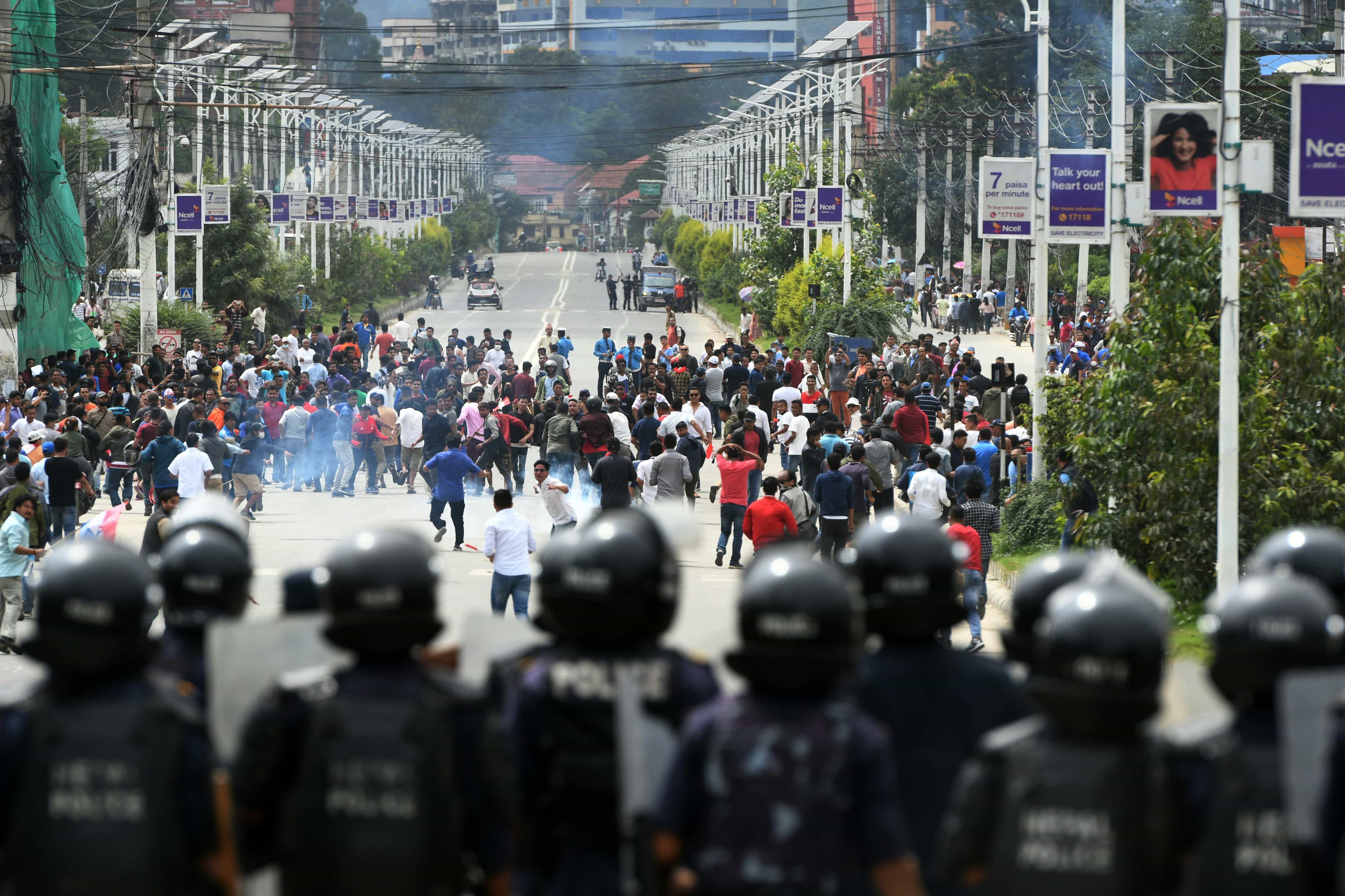 Nepali police use tear gas to disperse crowds of the Tarun Dal, the youth wing of Nepali Congress Party, during a demonstration against the government, Kathmandu, Nepal, 21 July 2018, PRAKASH MATHEMA/AFP/Getty Images