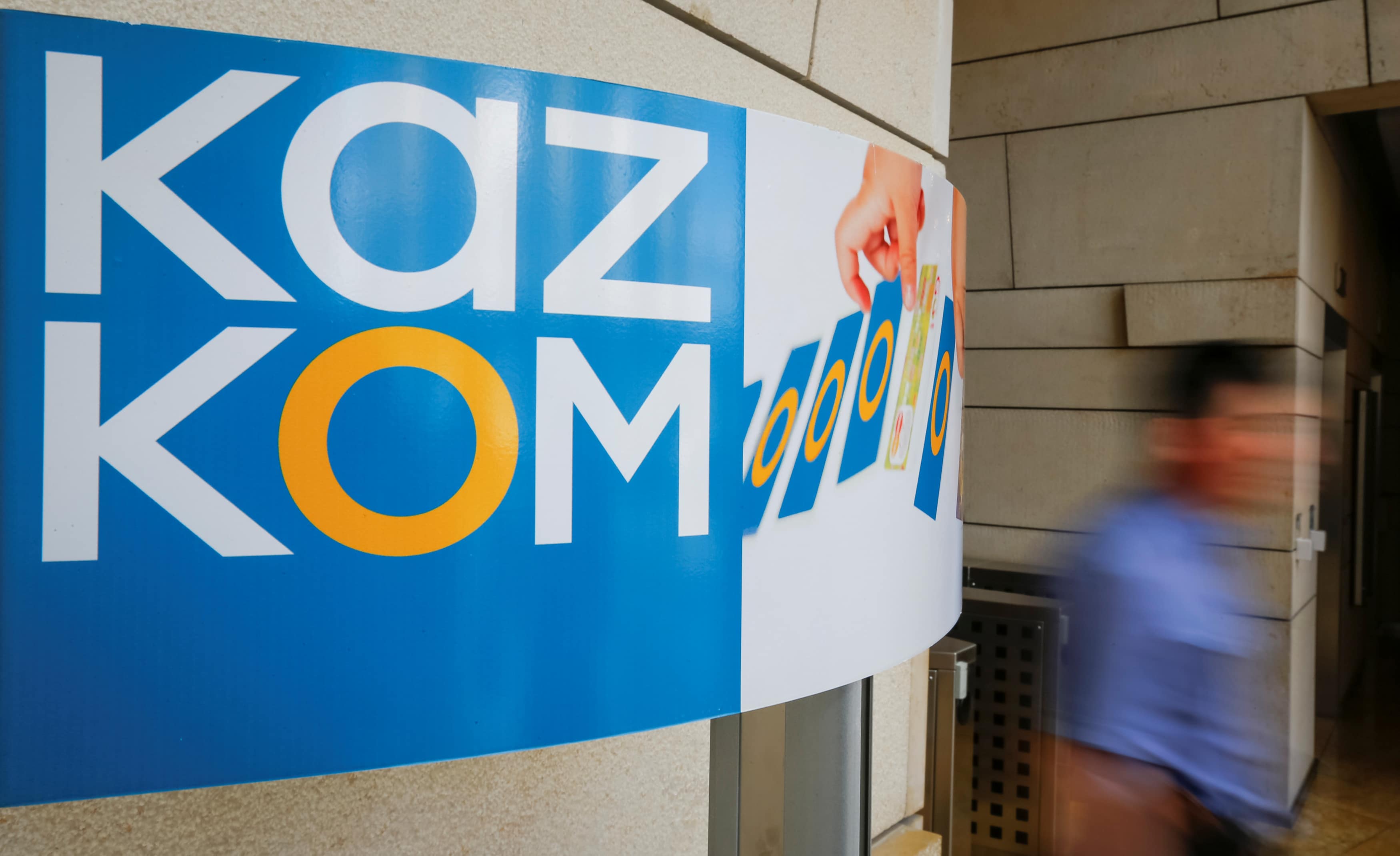 A man walks past a Kazkommertsbank (KKB) sign at its headquarters in Almaty, Kazakhstan, 5 May 2016, REUTERS/Shamil Zhumatov