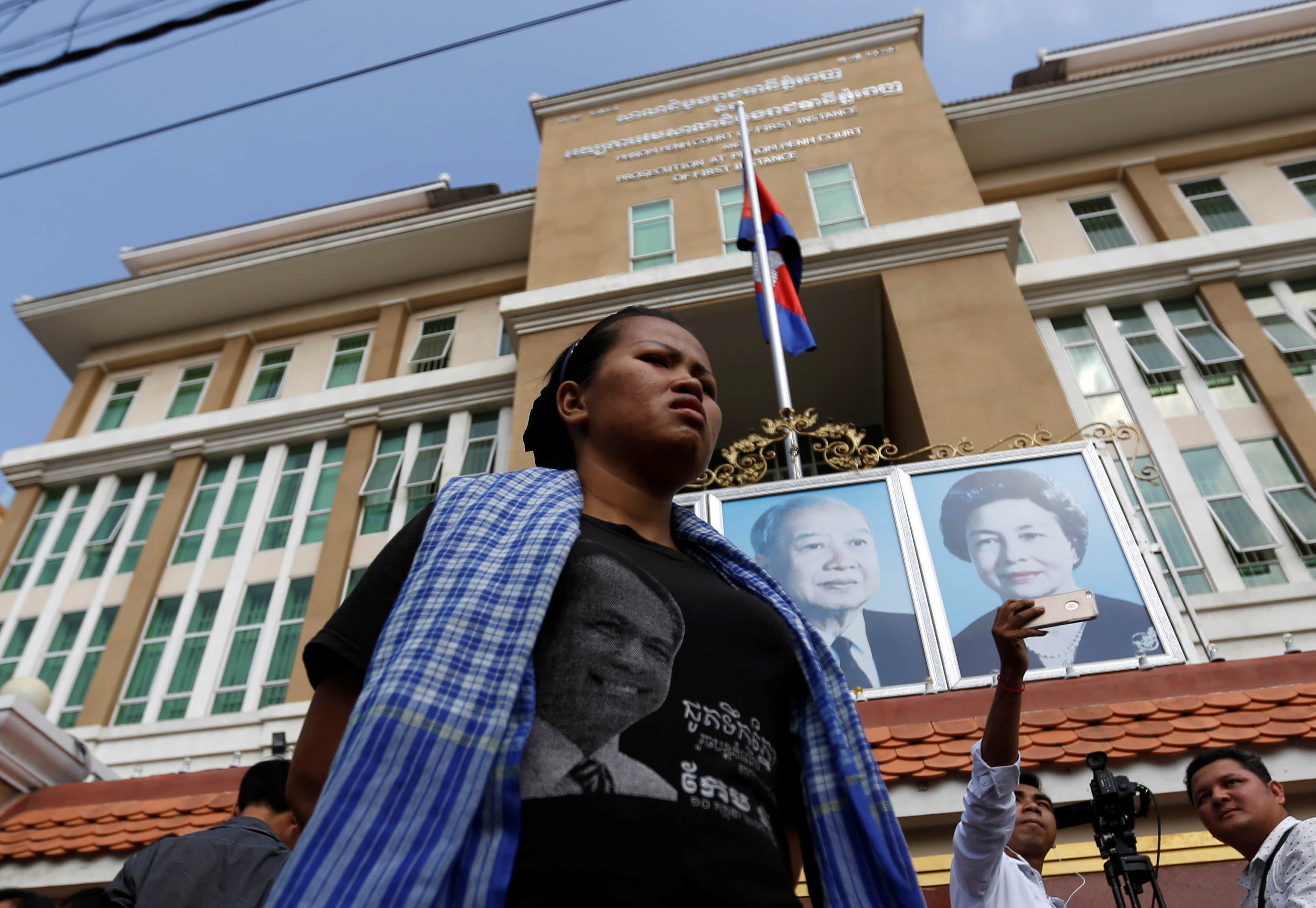 A grassroots supporter of the late Kem Ley stands outside the court building in Phnom Penh, Cambodia on 23 March 2017, REUTERS/Samrang Pring