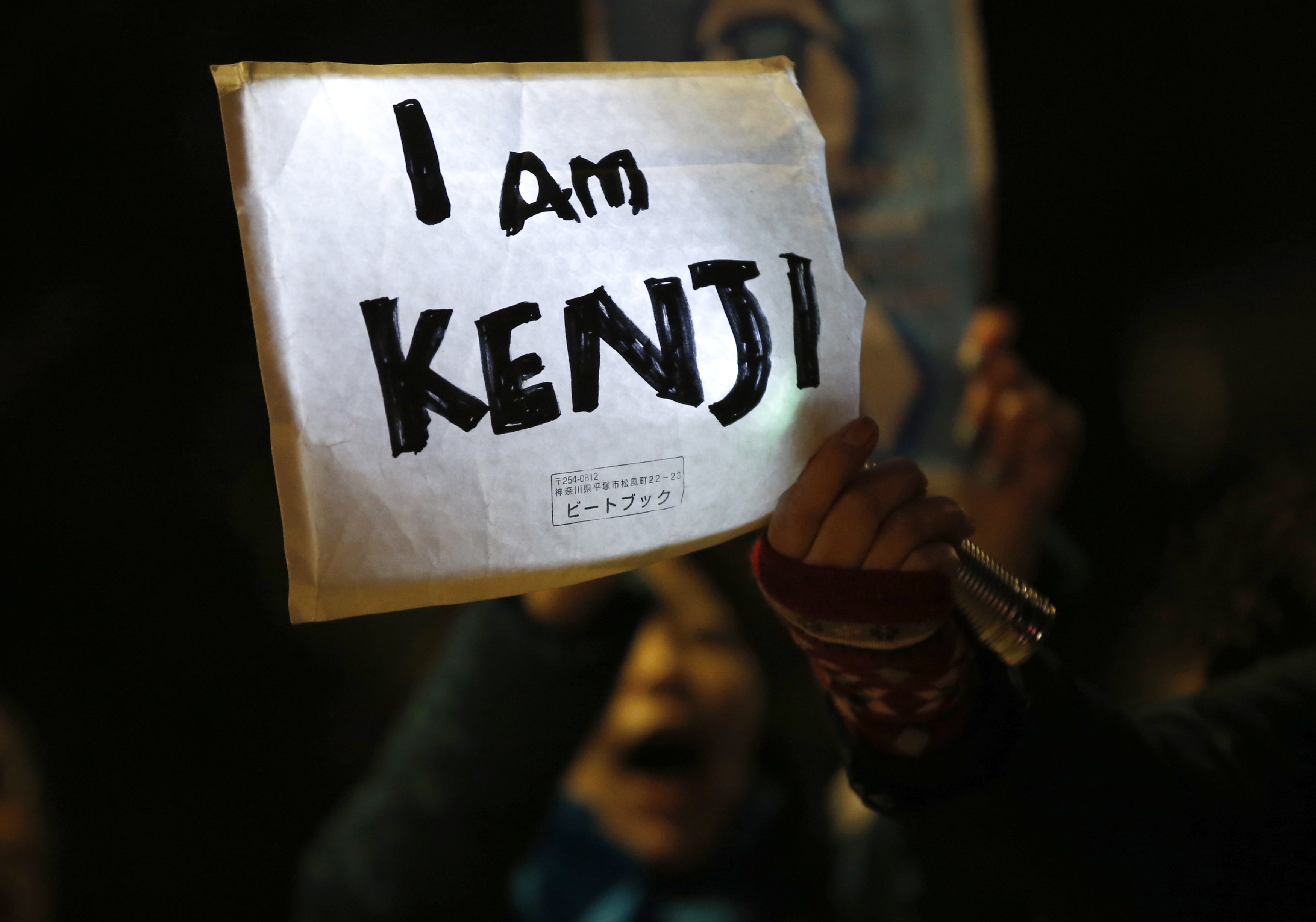 A protester holding a placard chants "Save Kenji" during a demonstration in front of the Prime Minister's Official residence in Tokyo before news of Goto's beheading was circulated, REUTERS/Toru Hanai