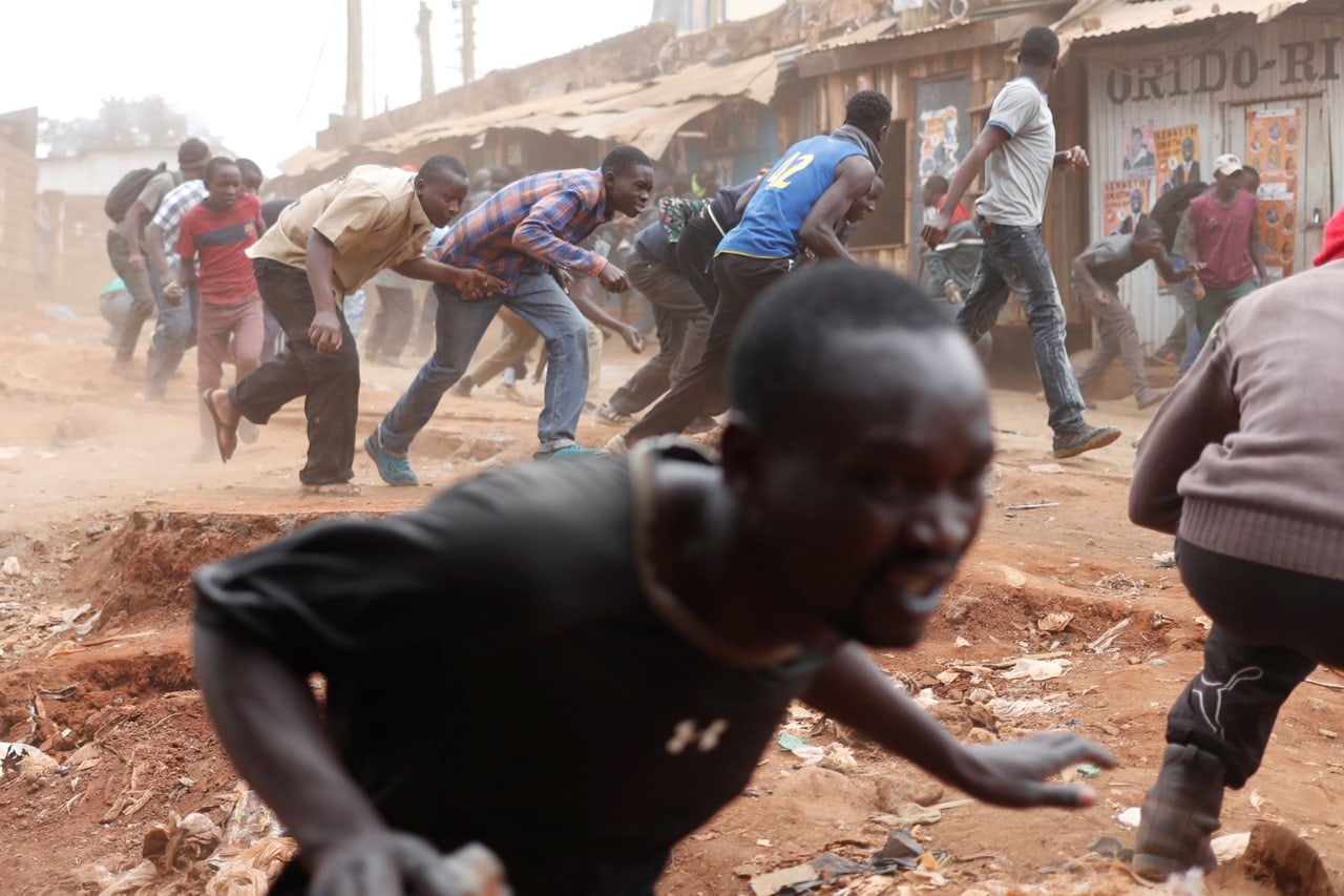 Supporters of opposition leader Raila Odinga run away from police during clashes in Kibera slum in Nairobi, Kenya, 12 August 2017, Reuters/Goran Tomasevic