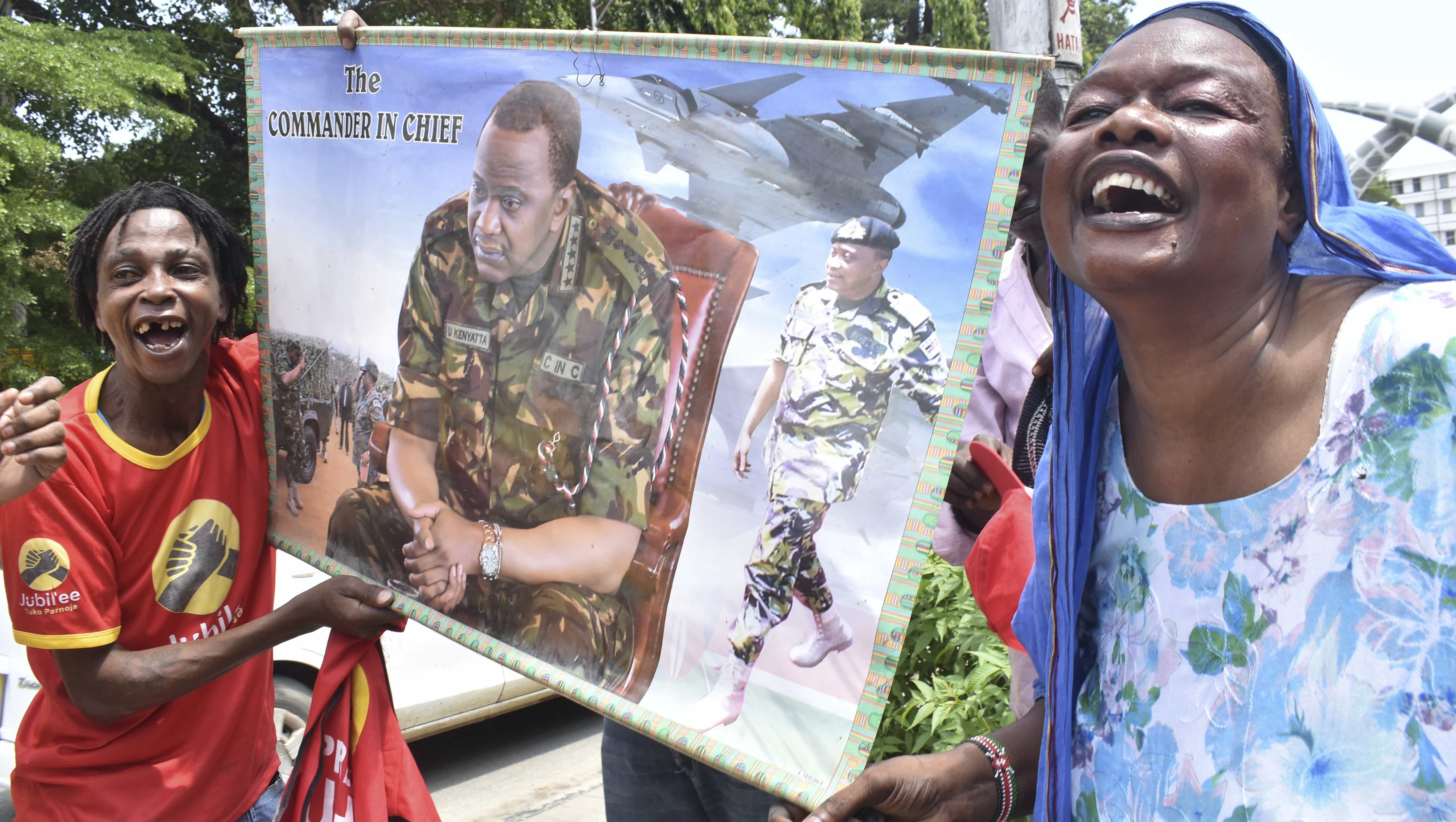 Supporters of Kenyan President Uhuru Kenyatta celebrate in Mombasa, 20 November 2017, after the Supreme upheld Kenyatta's re-election in a repeat vote, AP Photo