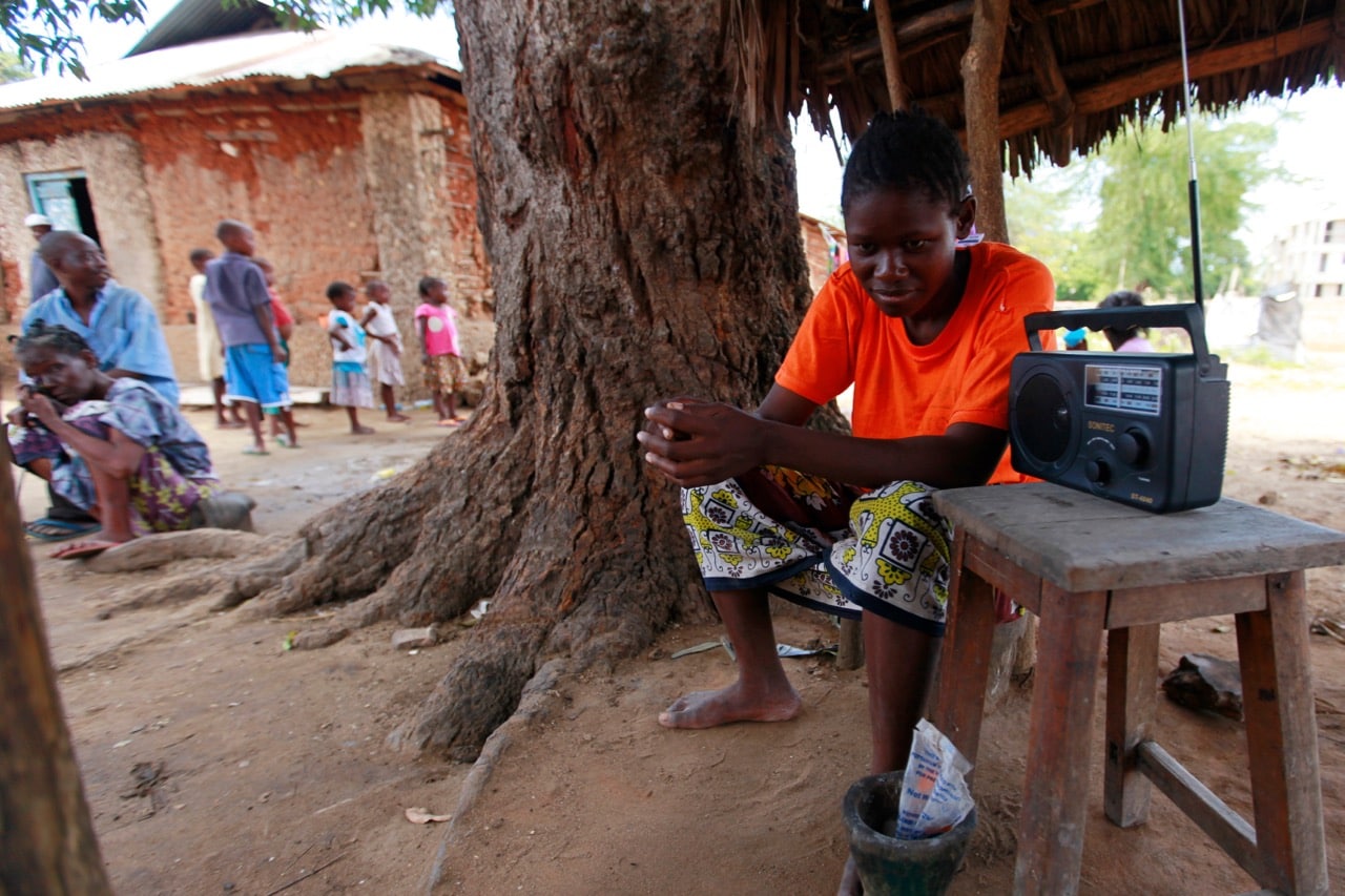 A young man listens to a radio to hear news on election results in the Mishomoroni area of Mombasa, Kenya, 6 March 2013, REUTERS/Joseph Okanga