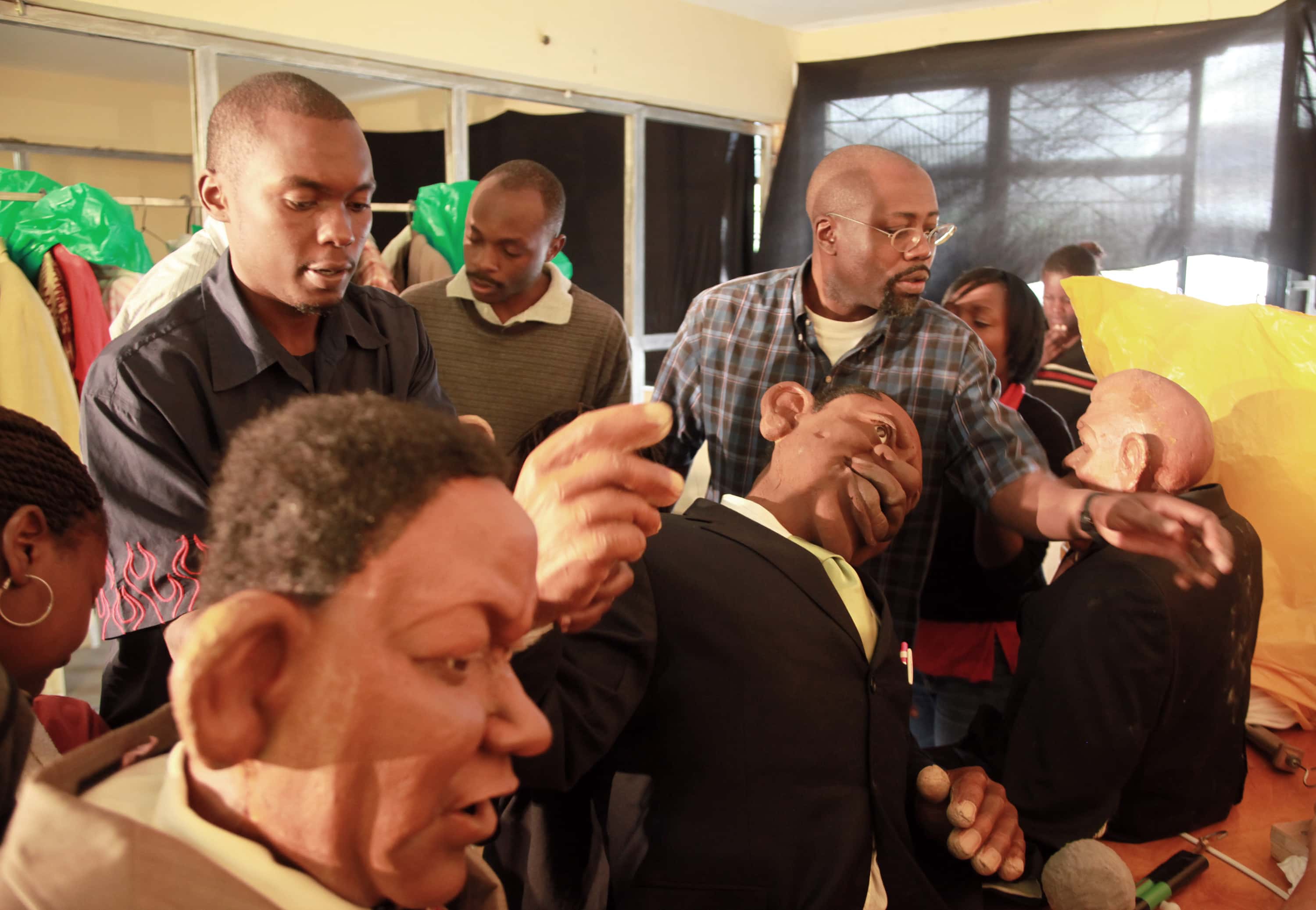 Godfrey Gado Mwampembwa, right, prepares for the XYZ show (a satirical puppet show that he created) at his studio in Nairobi, 21 May 2009., AP Photo/Sayyid Azim