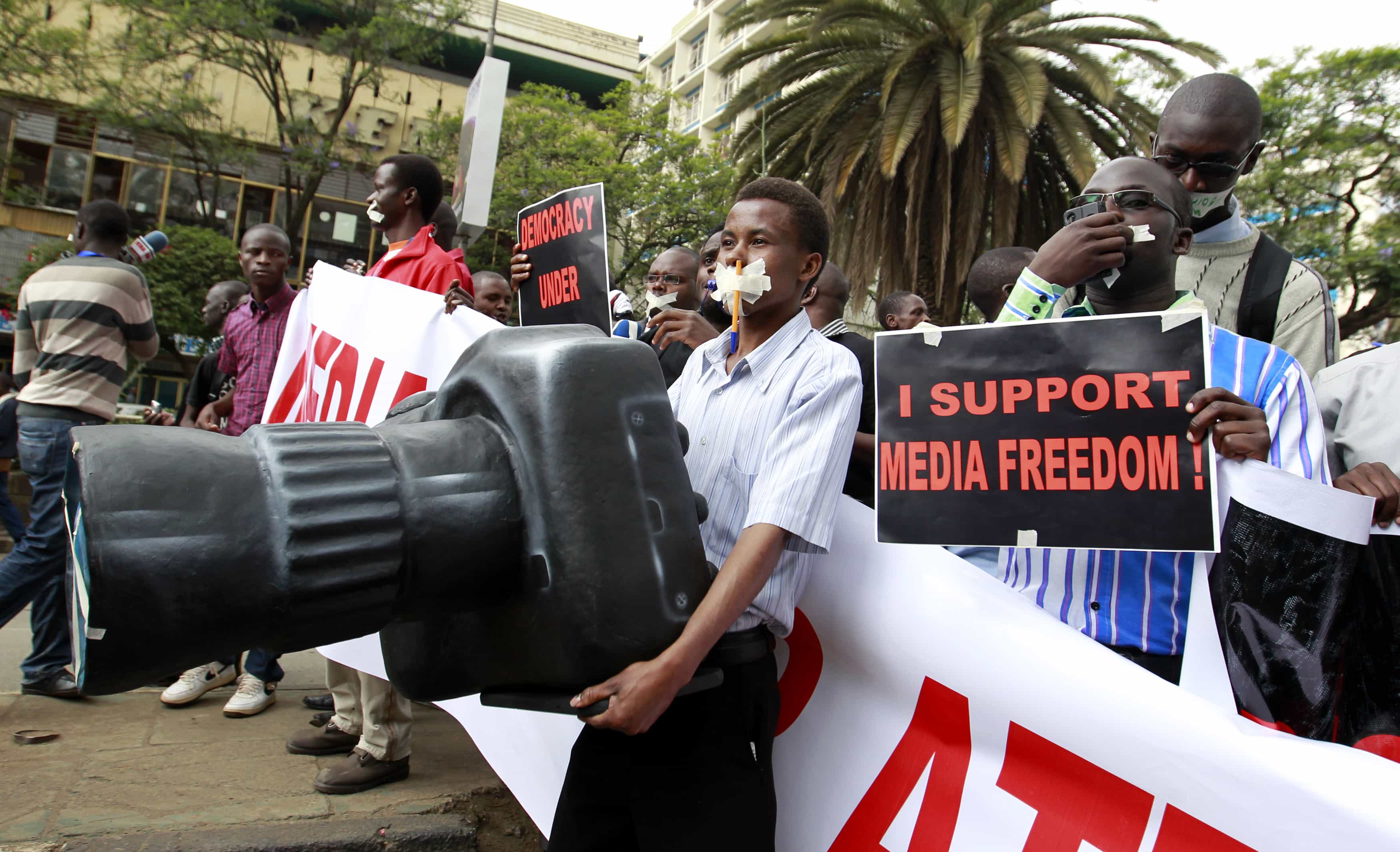 A Kenyan journalist carries a plastic replica of a camera as he participates in a protest along the streets of the capital Nairobi, 3 December 2013., REUTERS/Thomas Mukoya