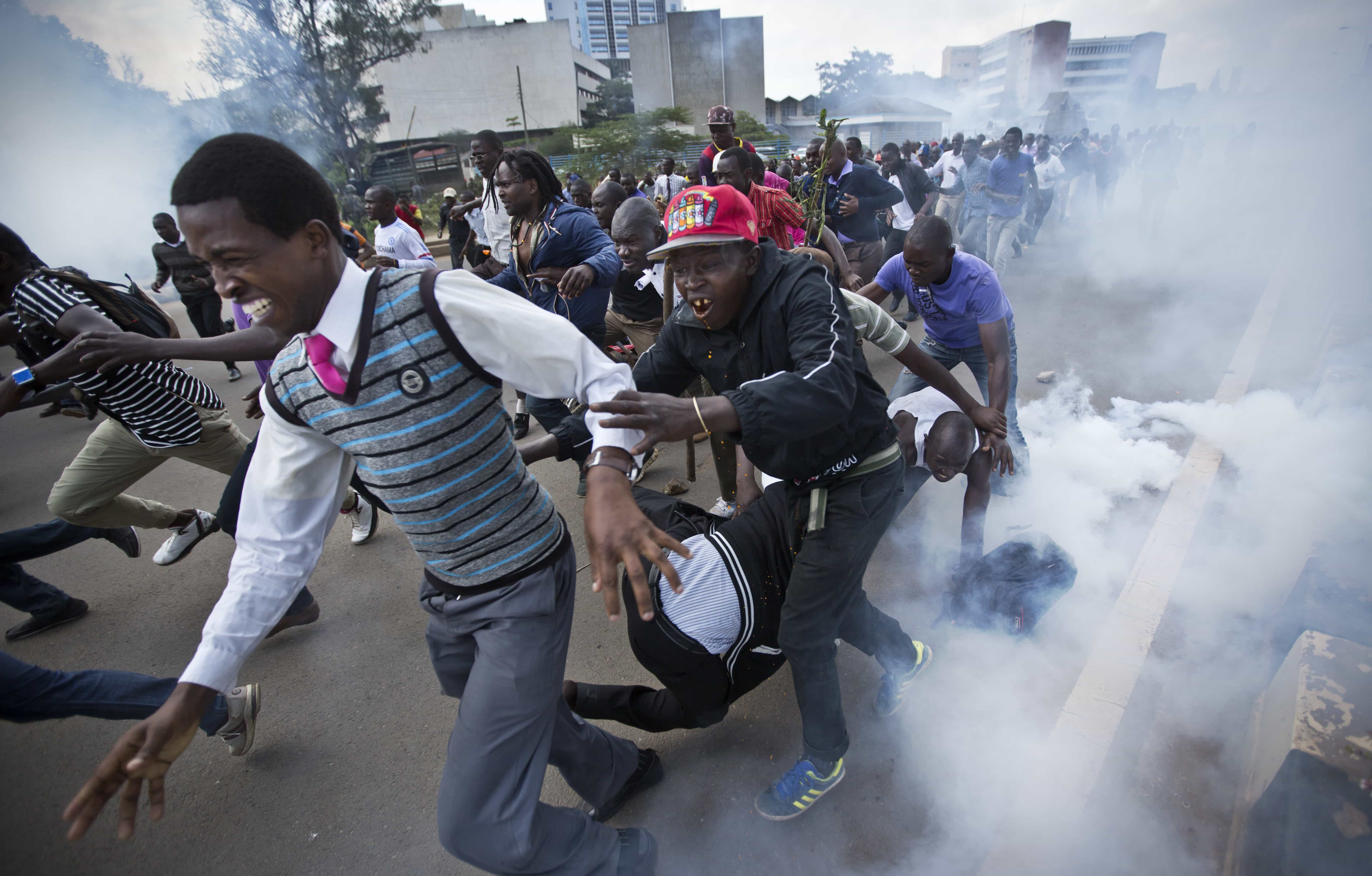 Opposition supporters flee from tear gas grenades fired by riot police, during a protest in downtown Nairobi, 16 May 2016, AP Photo/Ben Curtis