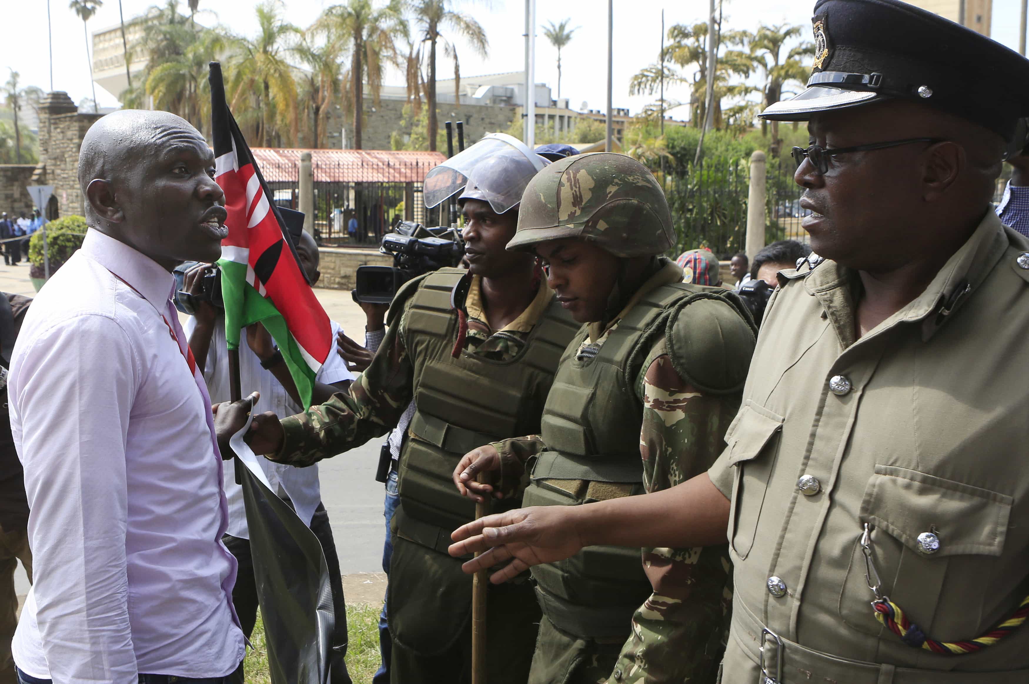 Police stop a protester from demonstrating for freedom of speech to be respected outside Kenya's parliament in Nairobi, 18 December 2014, REUTERS/Noor Khamis