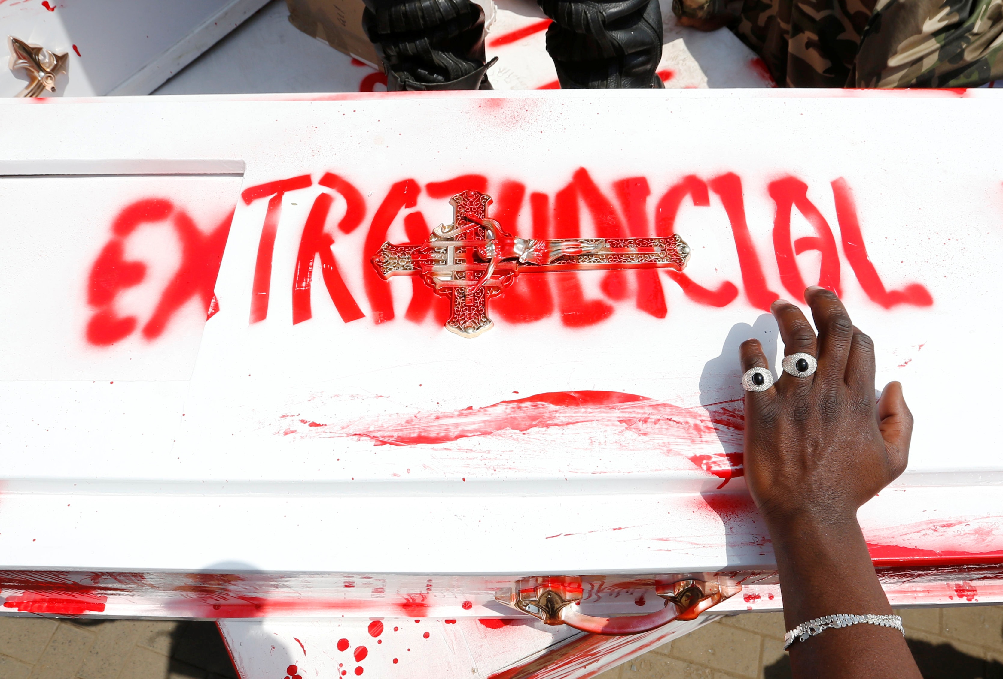 A member of the civil society holds a coffin stained with mock blood as others chant slogans, during a protest dubbed "Stop extrajudicial killings" on the killing of human rights lawyer, Willie Kimani, his client and their driver in Nairobi, Kenya, 4 July 2016