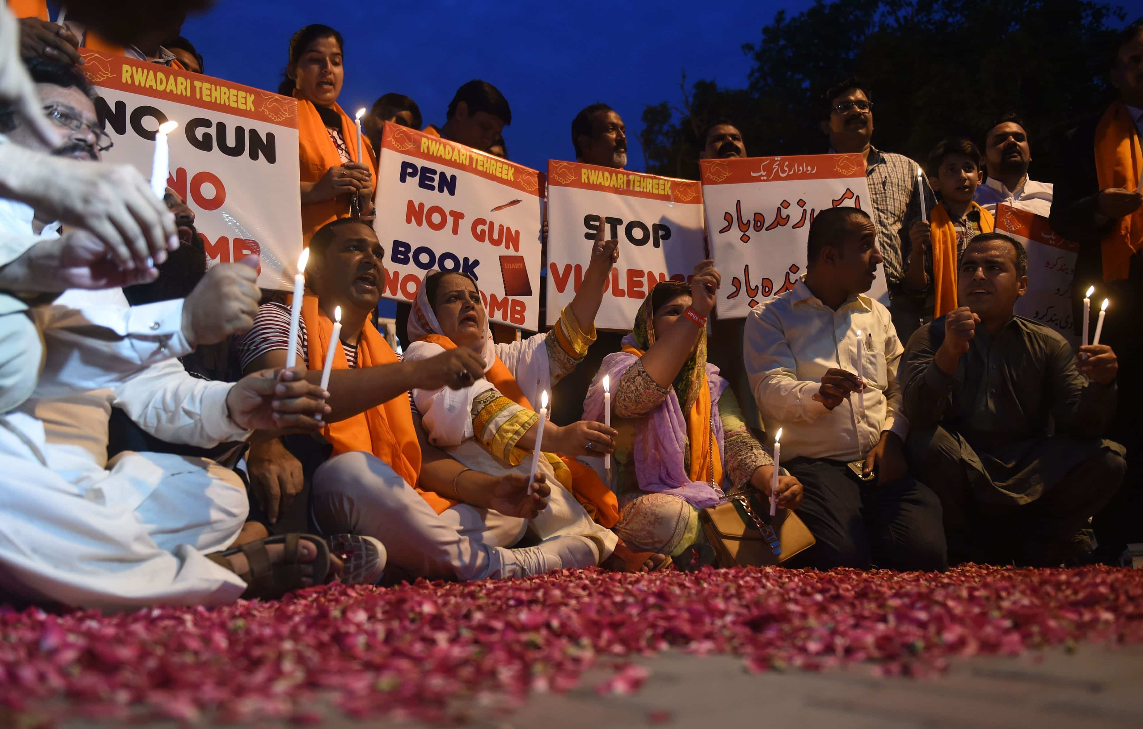 Mourners hold candles and placards during a vigil hours after an explosion left 20 dead in the first major attack ahead of July 25 polls, Lahore, India, 2018, ARIF ALI/AFP/Getty Images