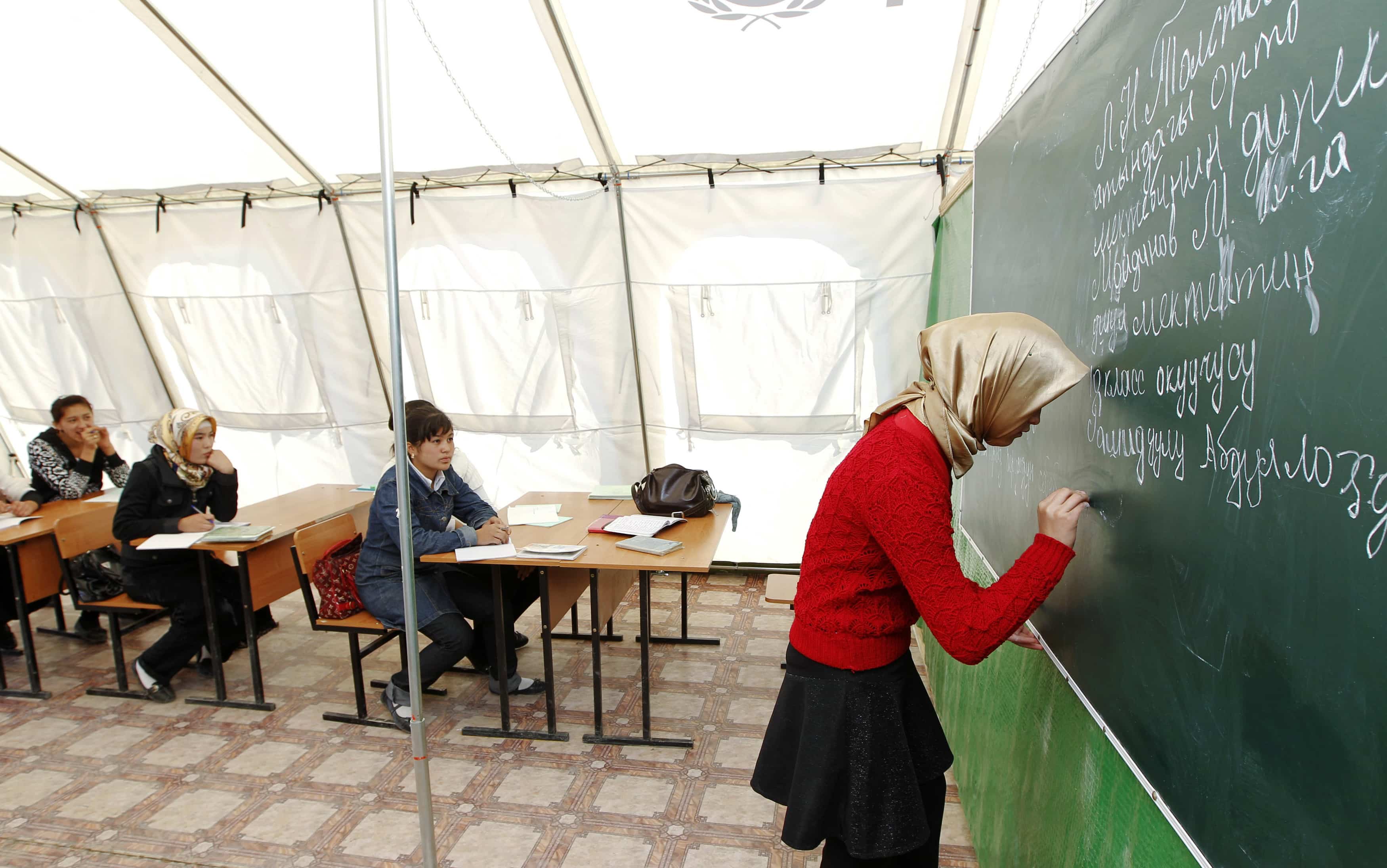 Children attend a lesson at a local school, based in a tent, in the city of Osh, 9 October 2010, REUTERS/Vasily Fedosenko