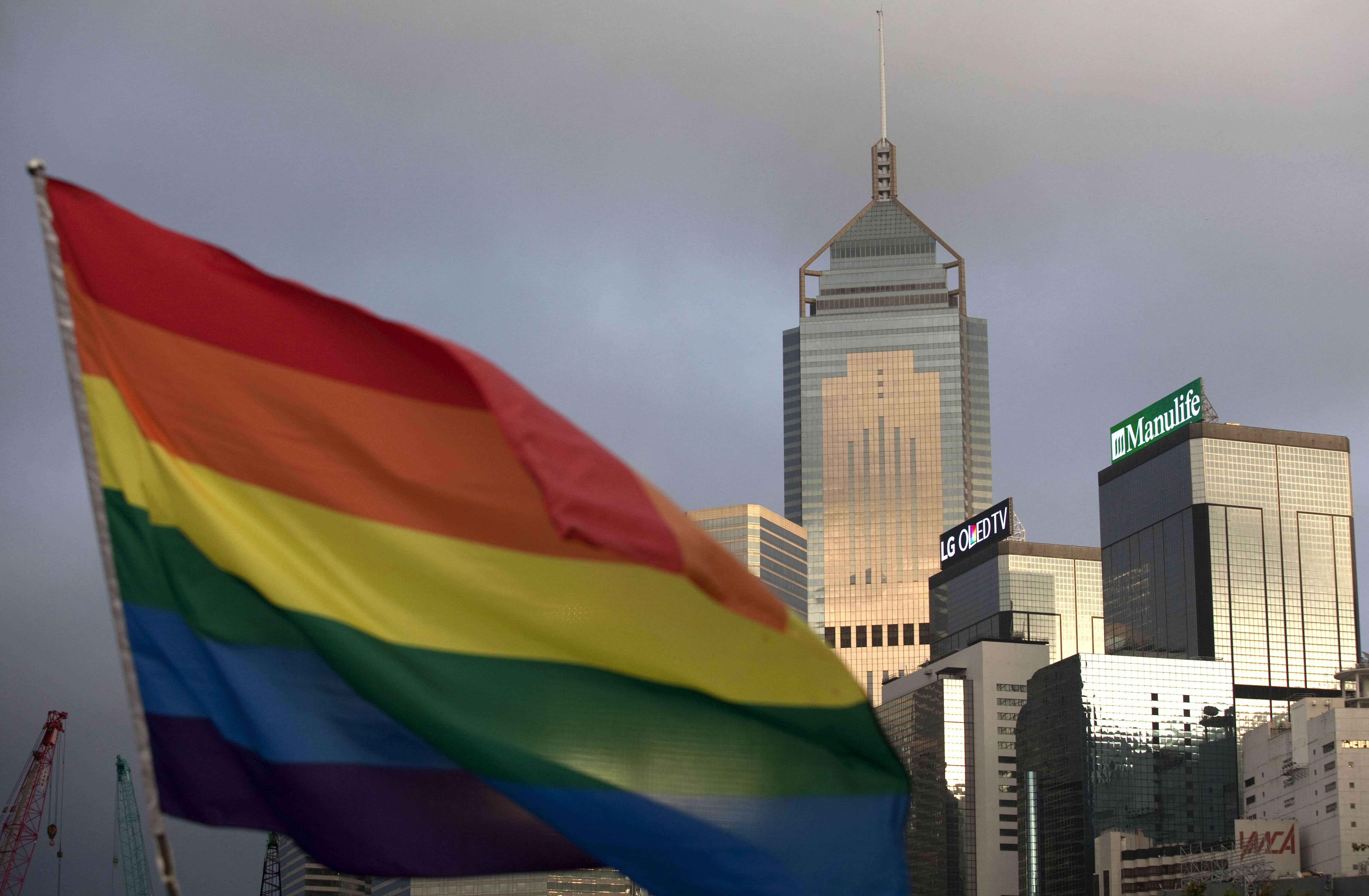 LGBTQI+ Pride flag flies in front of skyline, Hong Kong, China, 6 November 2015, Isaac Lawrence/AFP/Getty Images