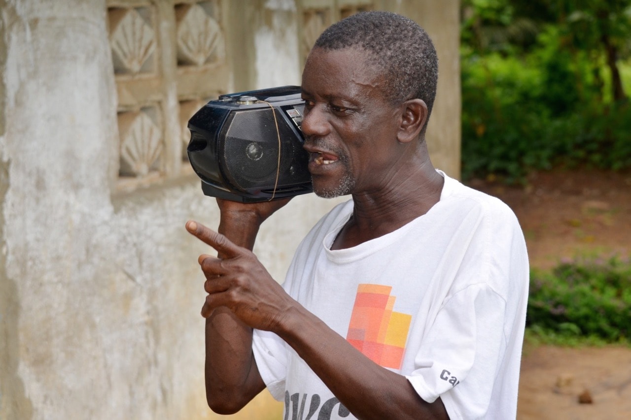 A man listens to a radio in Buchanan, Liberia, 4 October 2014, ZOOM DOSSO/AFP/Getty Images