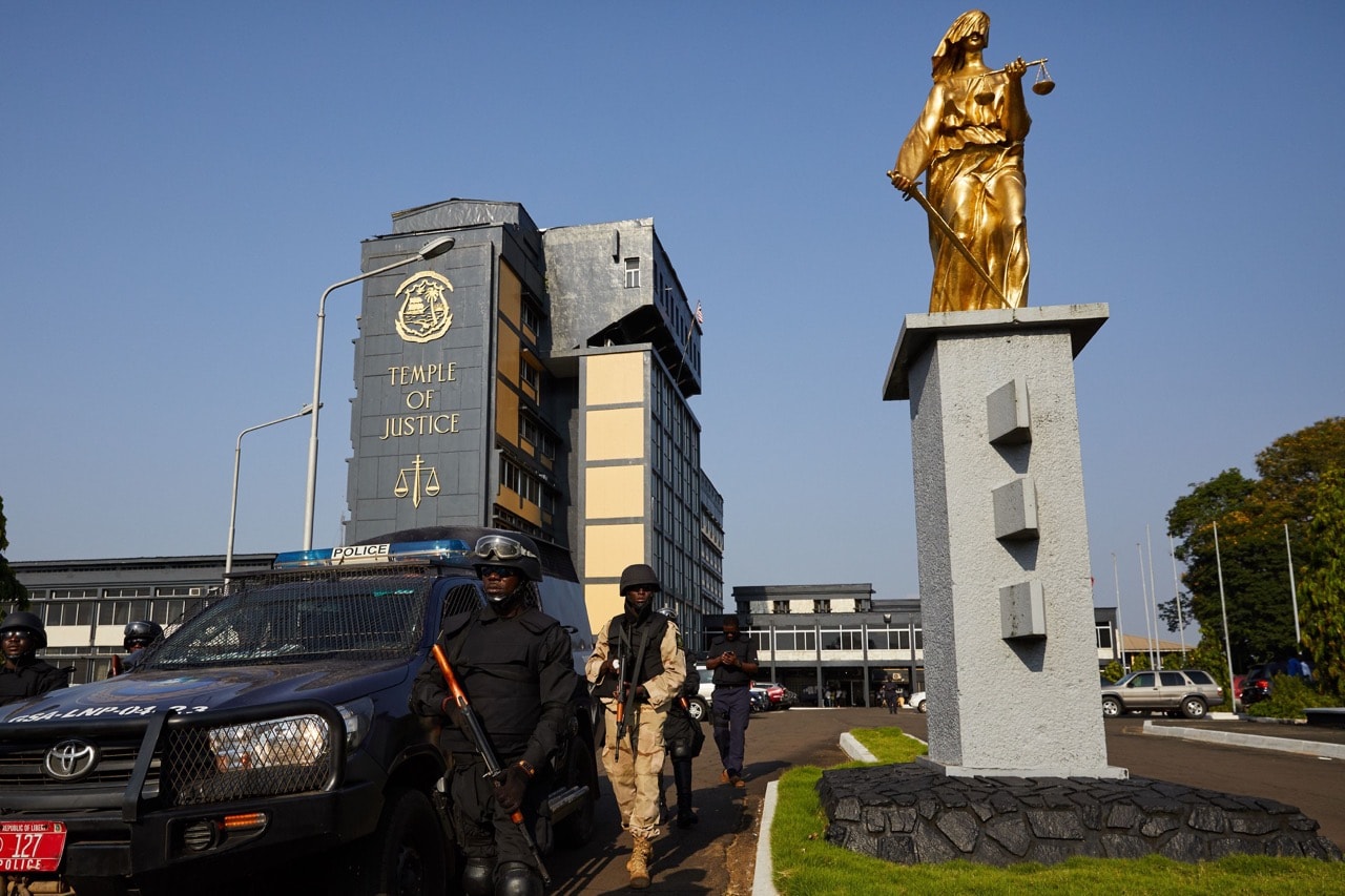 Policemen patrol outside the Supreme Court in Monrovia, Liberia, 7 December 2017, HUGH KINSELLA CUNNINGHAM/AFP/Getty Images