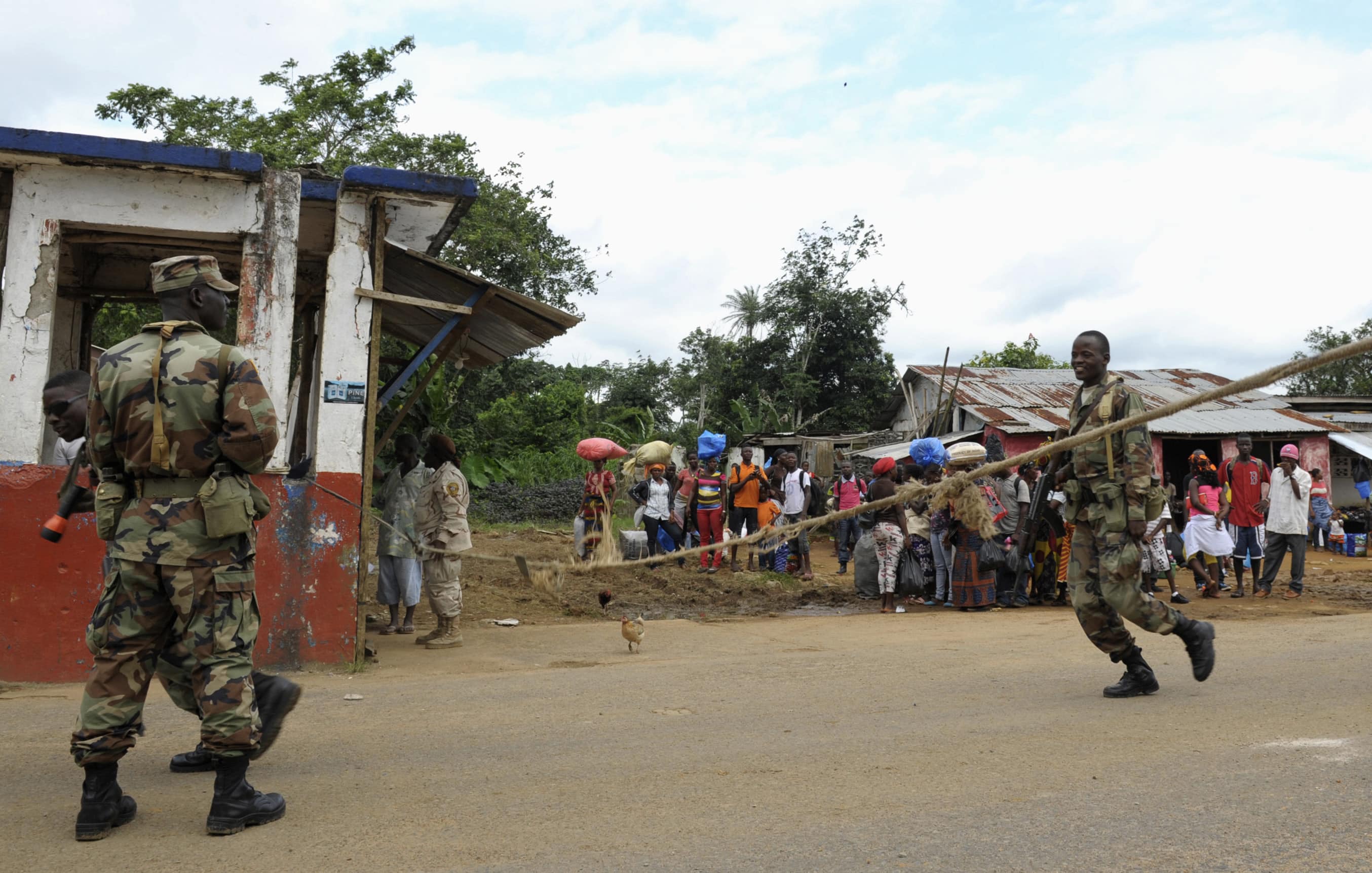 Liberian soldiers check people travelling in Bomi County, 11 August 2014. Liberian troops set up Ebola roadblocks and stopped public access to some of the worst-hit towns after the country declared a state of emergency, REUTERS/Stringer