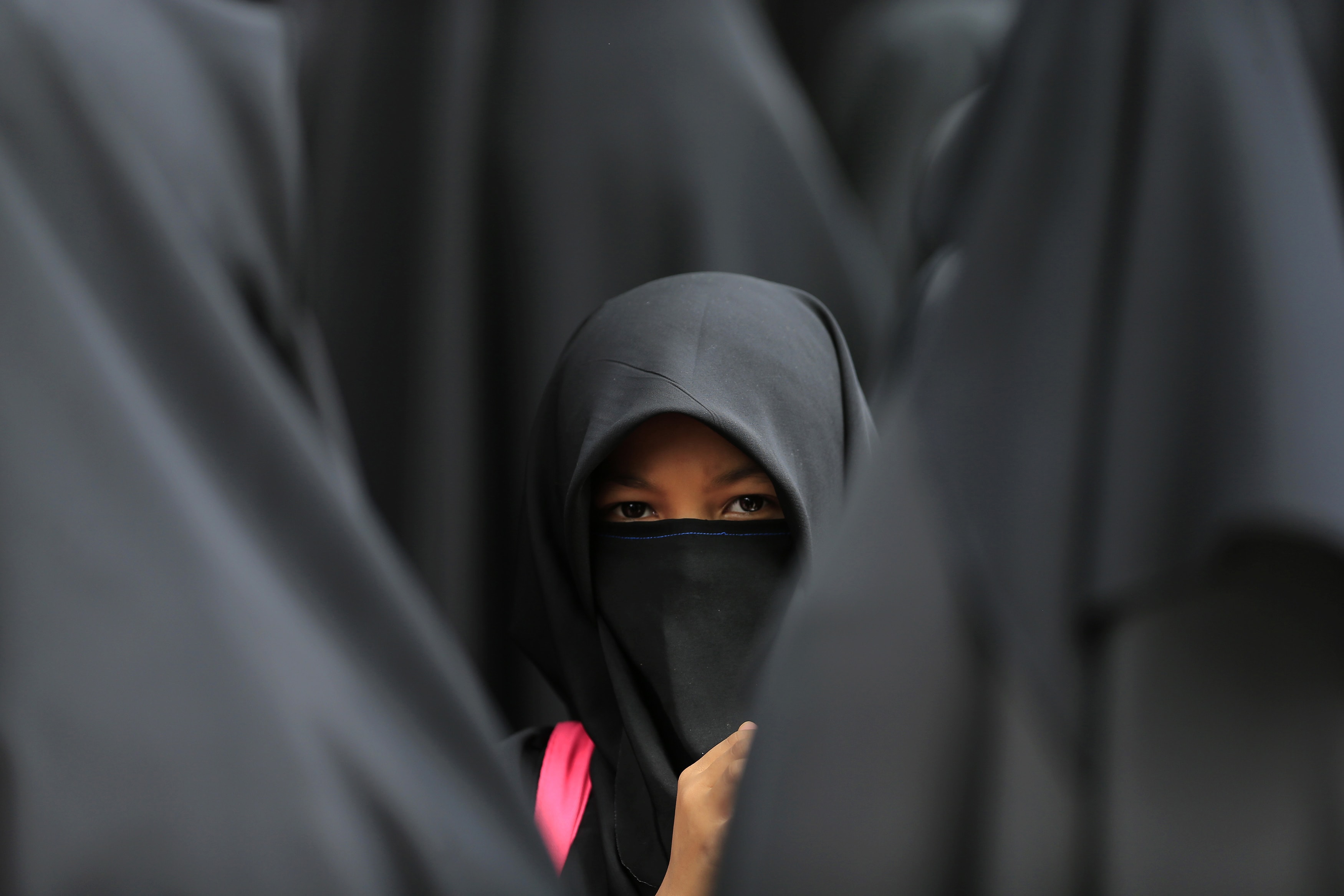 A girl wearing a hijab waits at the Shah Alam stadium during celebrations of Maulidur Rasul, or the birth of Prophet Muhammad, outside Kuala Lumpur, 14 January 2014, REUTERS/Samsul Said