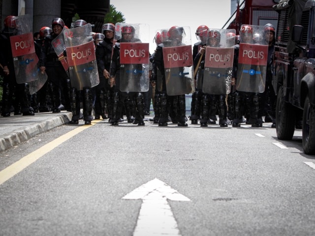 In this Feb 10, 2015 photo, Malaysian police stands guard during a protest outside the Palace of Justice in Putrajaya, Malaysia, AP Photo/Joshua Paul