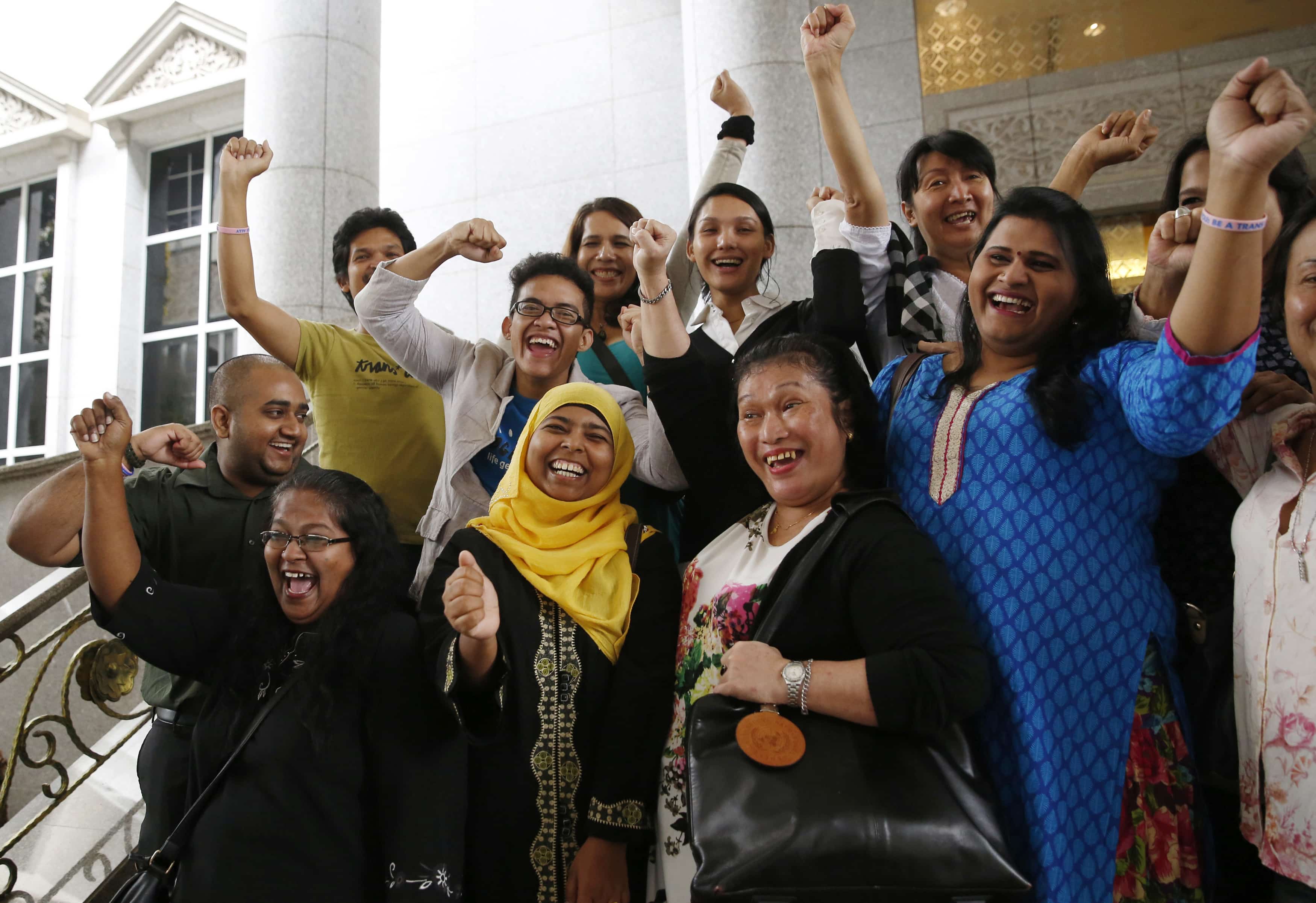 Activists celebrate the overturning of a sharia law against cross-dressing at the Appeals Court in the Palace of Justice in Putrajaya, 7 November 2014, REUTERS/Olivia Harris