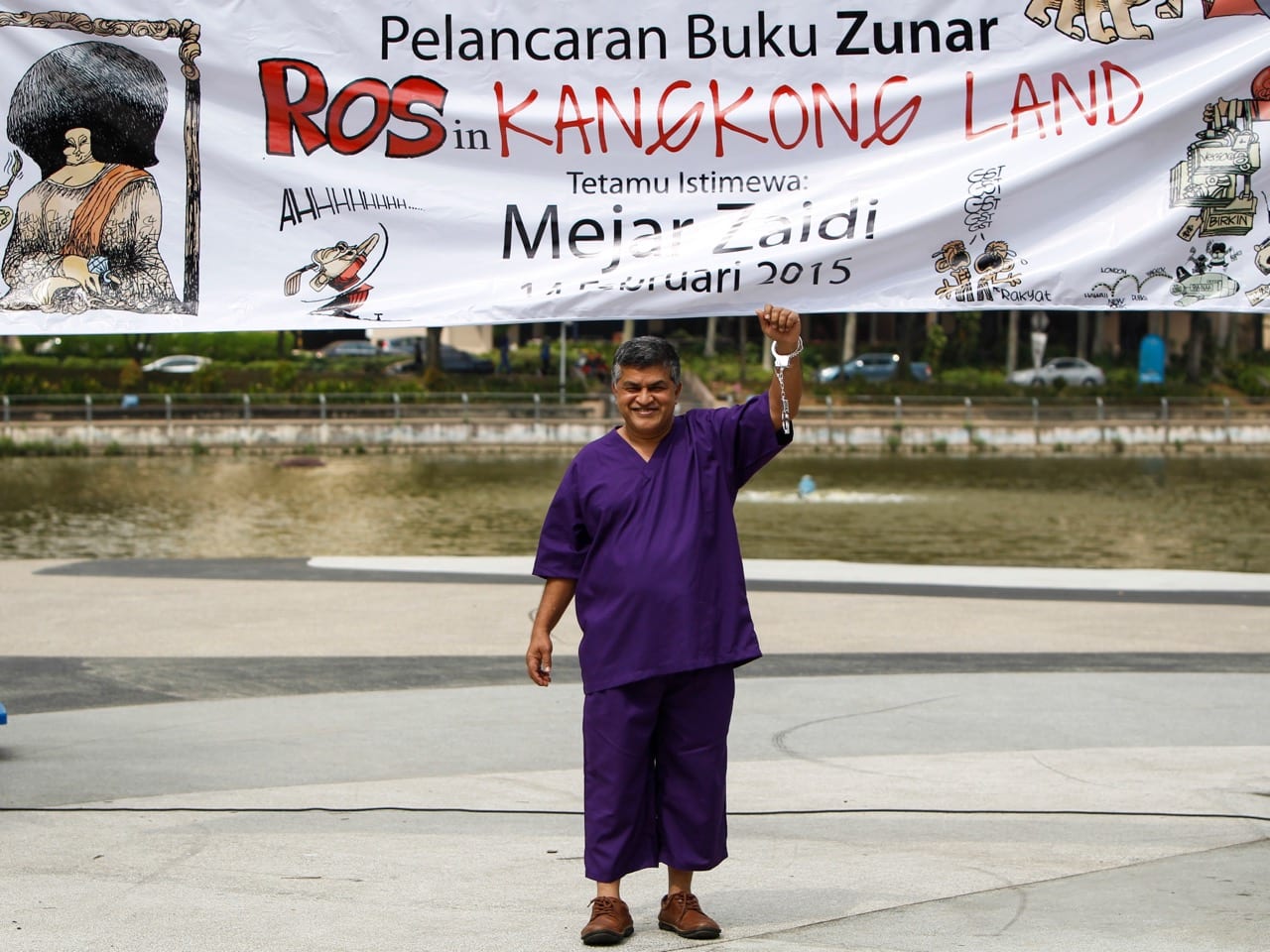Zunar, wearing a prison outfit and plastic handcuffs, poses for photographers prior to launching his book in Petaling Jaya, Malaysia, 14 February 2015 , AP Photo/Joshua Paul