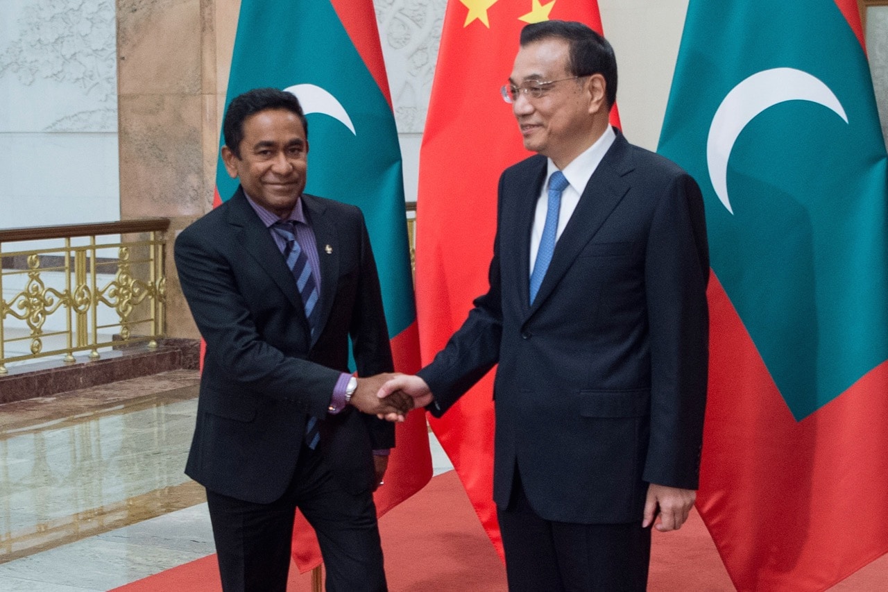 China's Premier Li Keqiang (R) shakes hands with Maldives' President Abdulla Yameen at the Great Hall of the People in Beijing, 7 December 2017, FRED DUFOUR/AFP/Getty Images