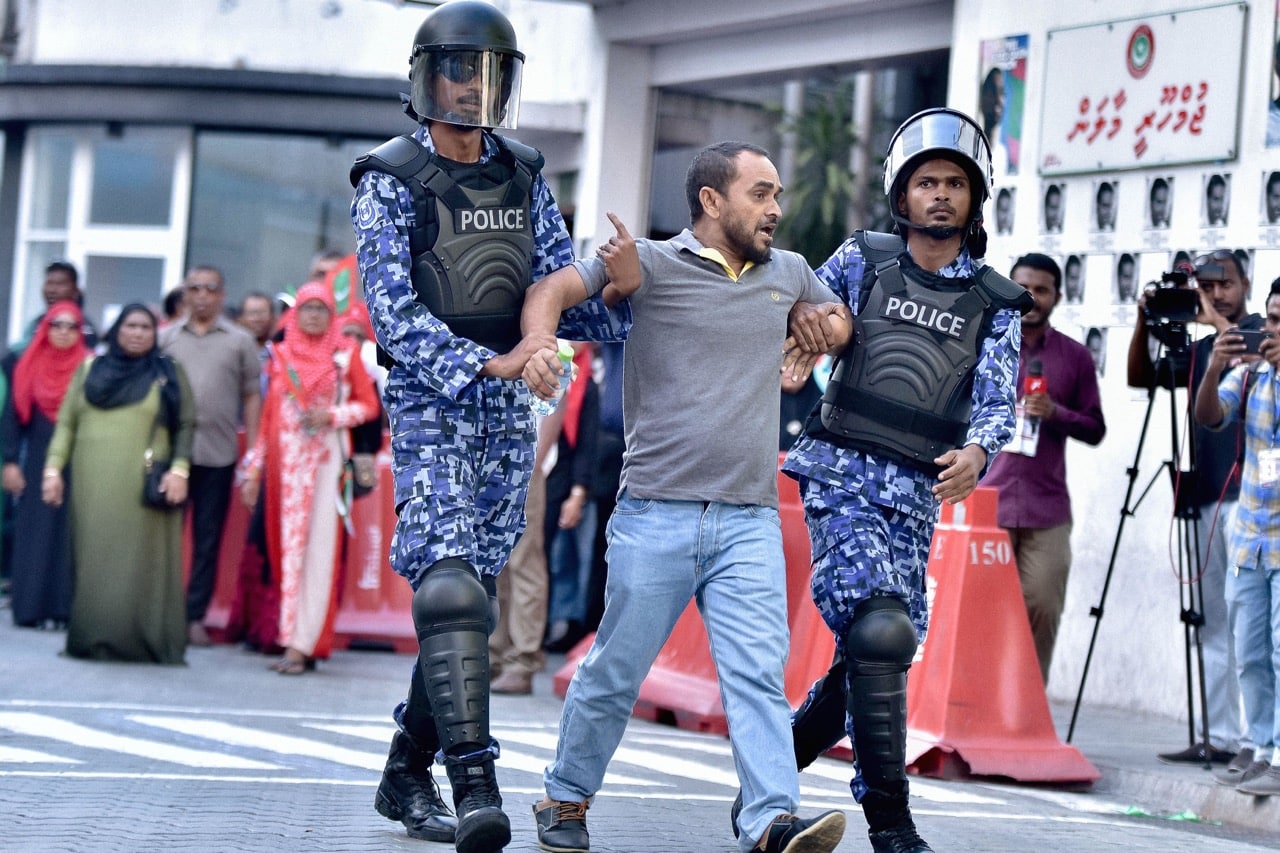 Police arrest a man at a protest appealing for the release of jailed opposition leaders in the Maldives capital Male, 2 March 2018, AHMED SHURAU/AFP/Getty Images