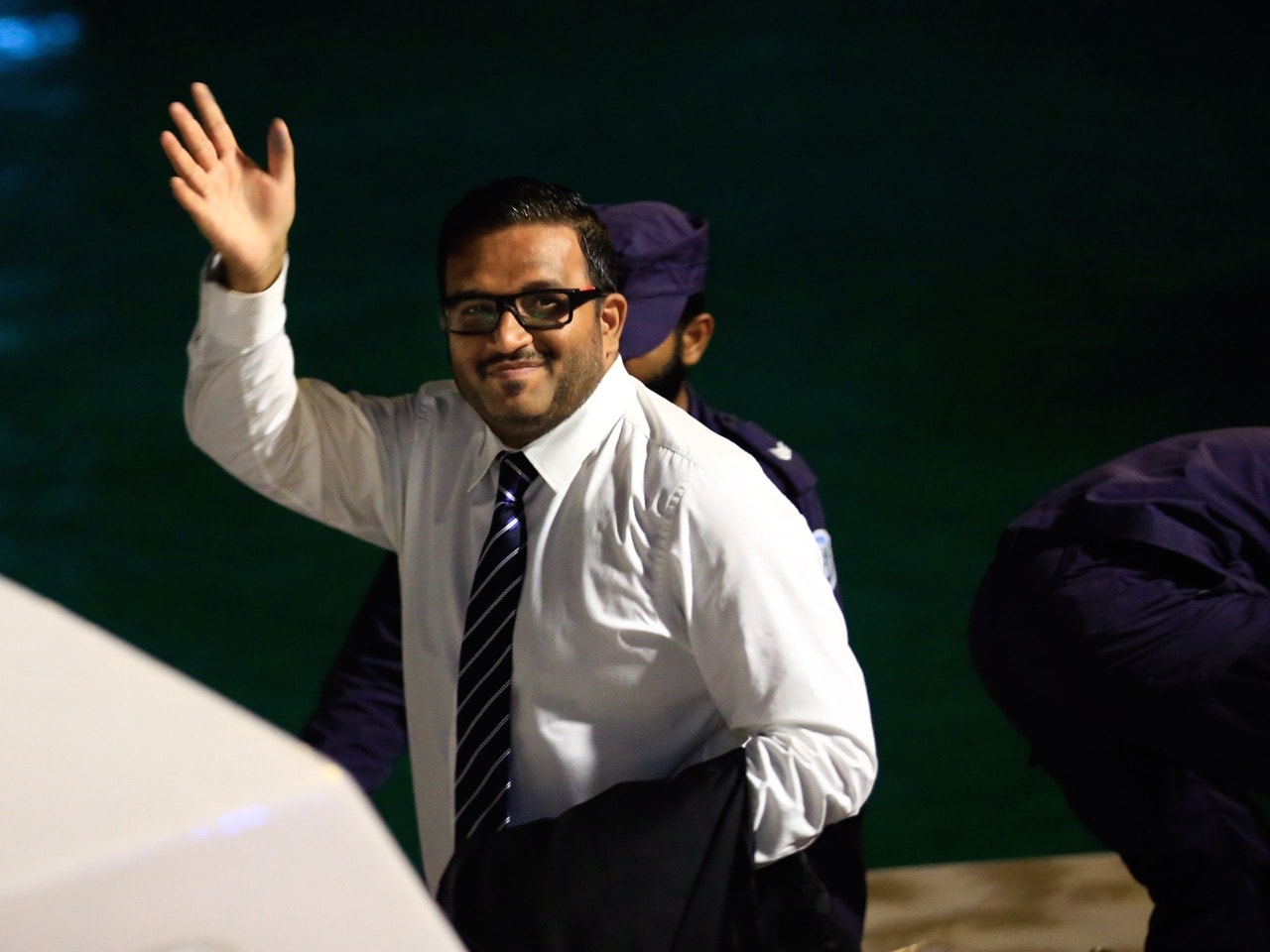 In this 10 June 2015 file photo, former Maldives vice president Ahmed Adeeb waves to the media before he boards a police speed boat in Maldives, AP Photo/Sinan Hussain, File