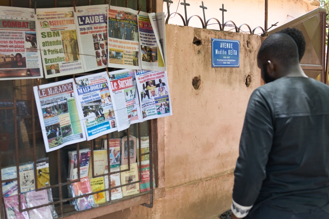 A man reads newspaper headlines at a stall in Bamako, Mali, 28 May 2018, MICHELE CATTANI/AFP/Getty Images