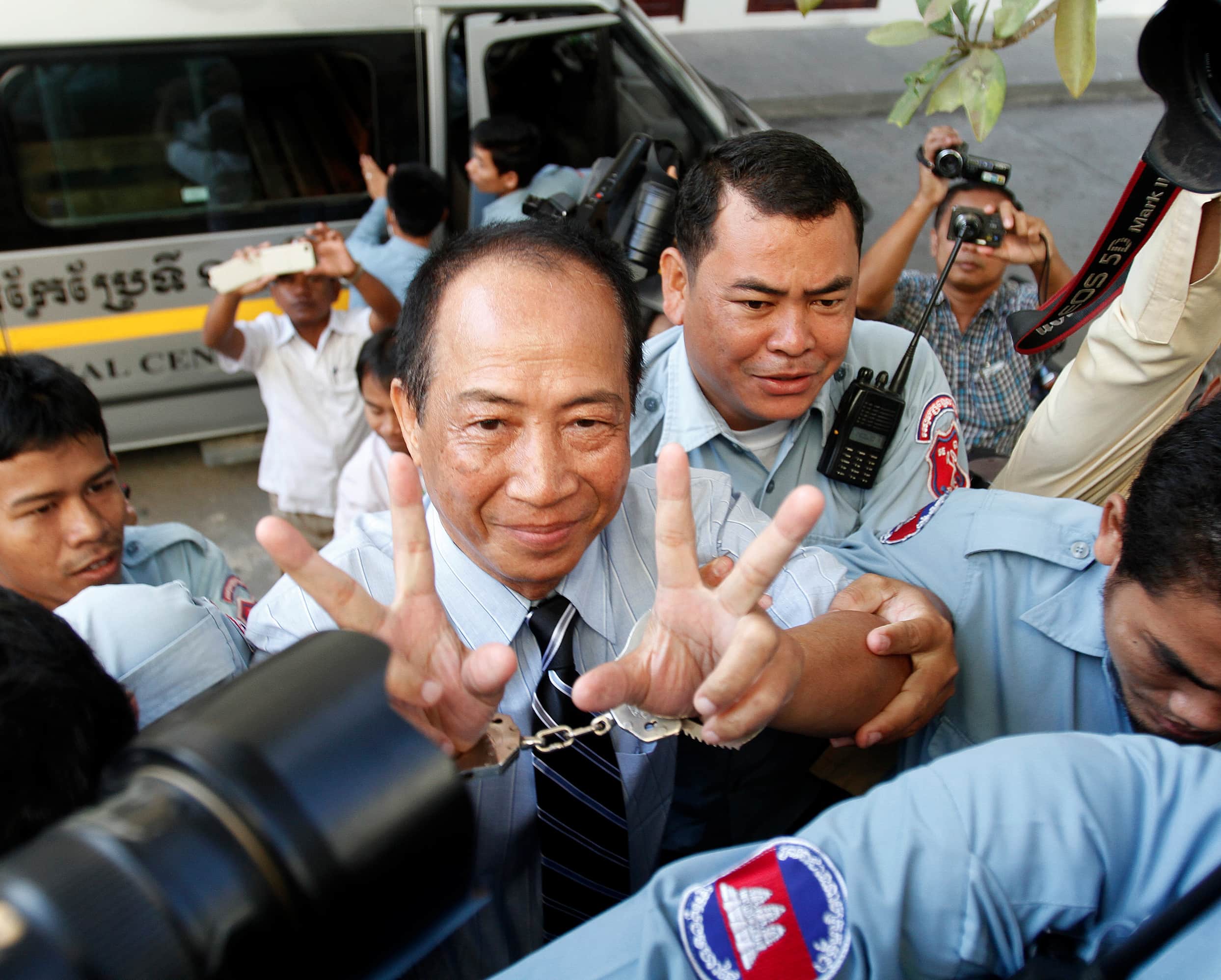 Mam Sonando gestures during his arrival at the Appeal Court in Phnom Penh on 14 December 2012, REUTERS/Pring Samrang