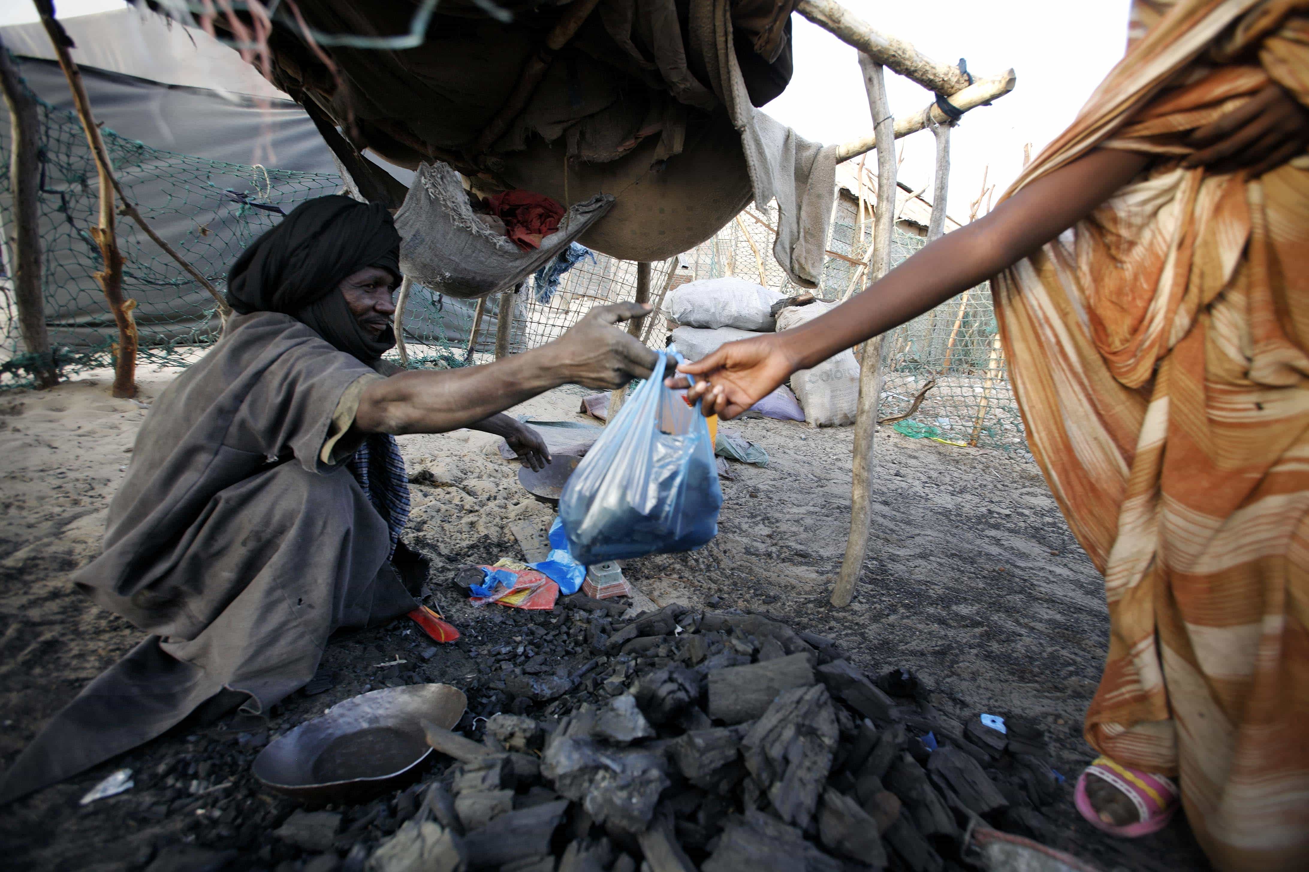 A Mauritanian man sells a bag of charcoal in the Keube slum in the capital Nouakchott in this March 13, 2007 picture. , REUTERS/Finbarr O'Reilly
