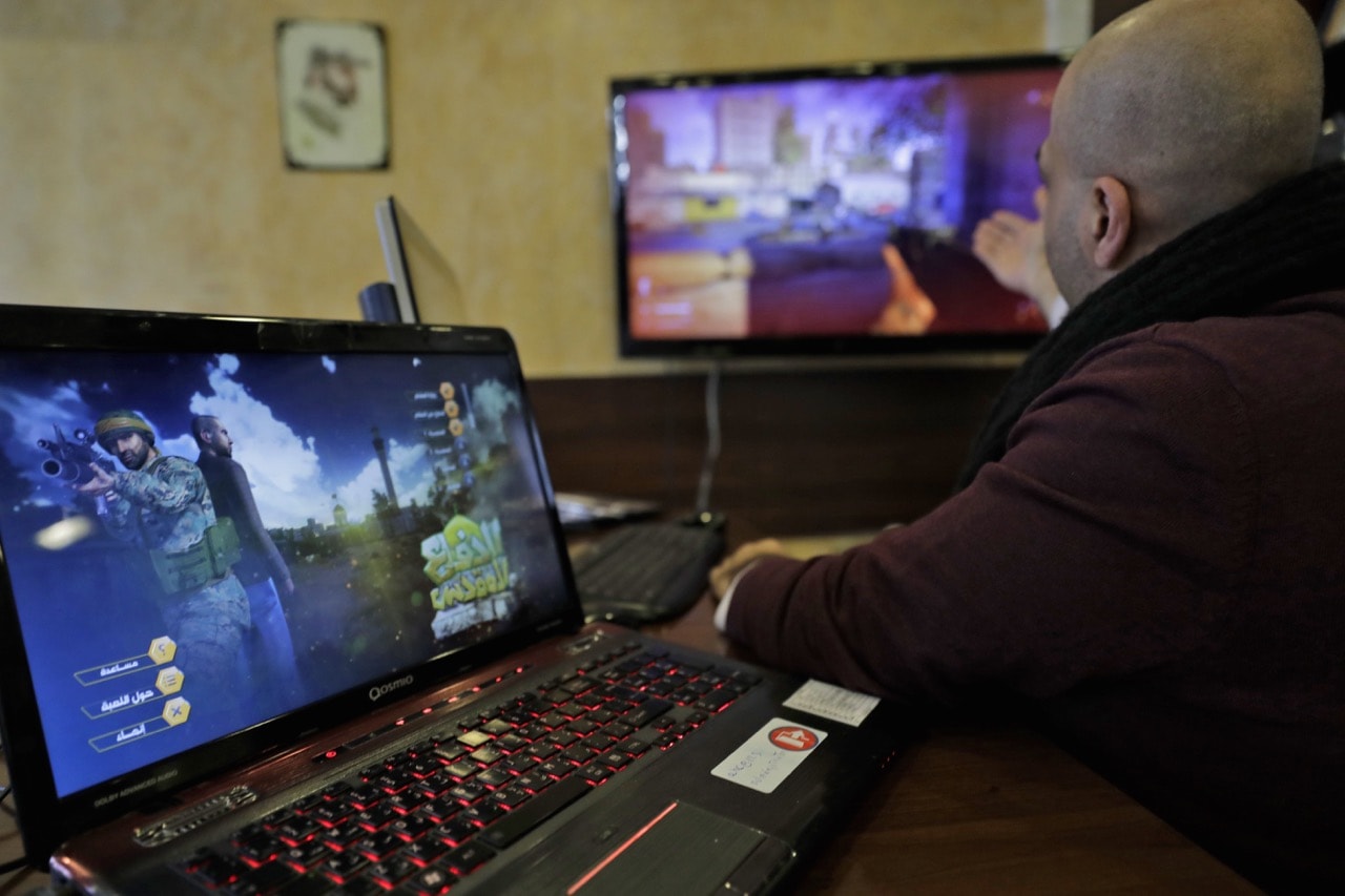 A Lebanese man plays a computer game inspired by the Syrian war, in a southern suburb of Beirut, 27 February 2018, JOSEPH EID/AFP/Getty Images