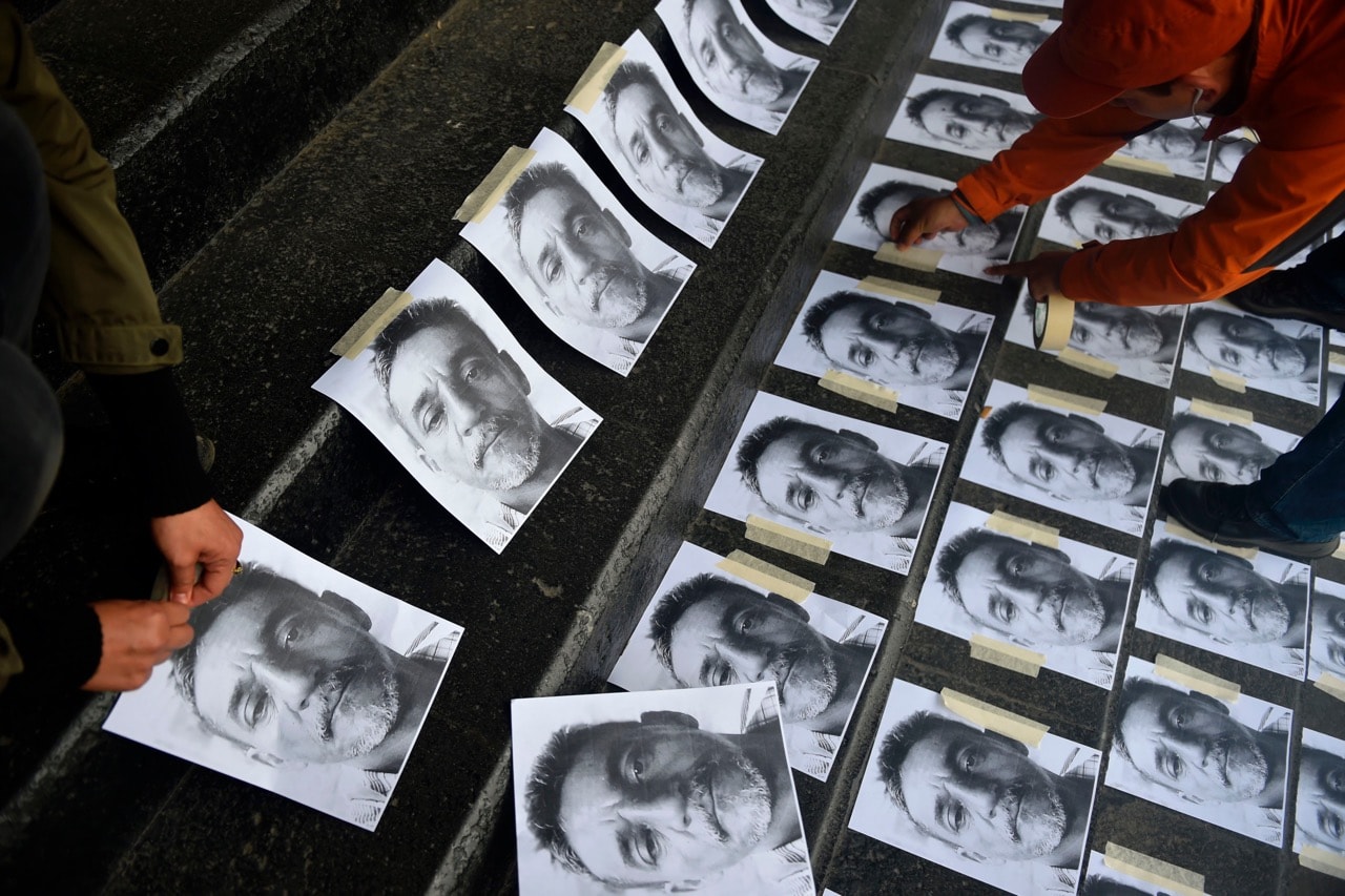 Journalists arrange pictures of slain Mexican colleague Candido Rios during a demonstration at the headquarters of the Ministry of the Interior in Mexico City, 24 August 2017, PEDRO PARDO/AFP/Getty Images