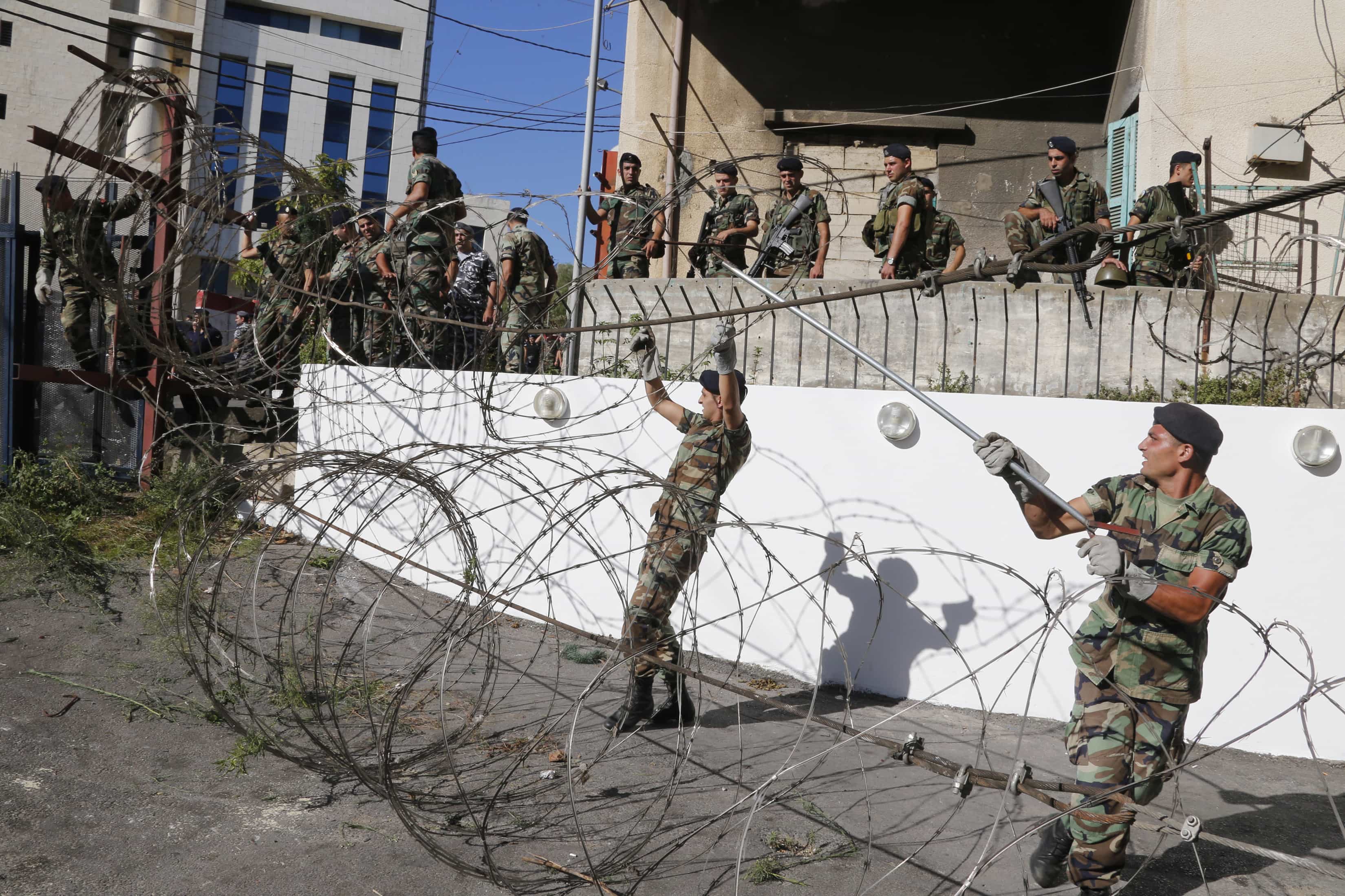 Lebanese army soldiers install barbed wire to close a road leading to the U.S. embassy in Awkar, north of Beirut, before a protest against potential U.S. strikes on Syria, September 6, 2013, REUTERS/Mohamed Azakir