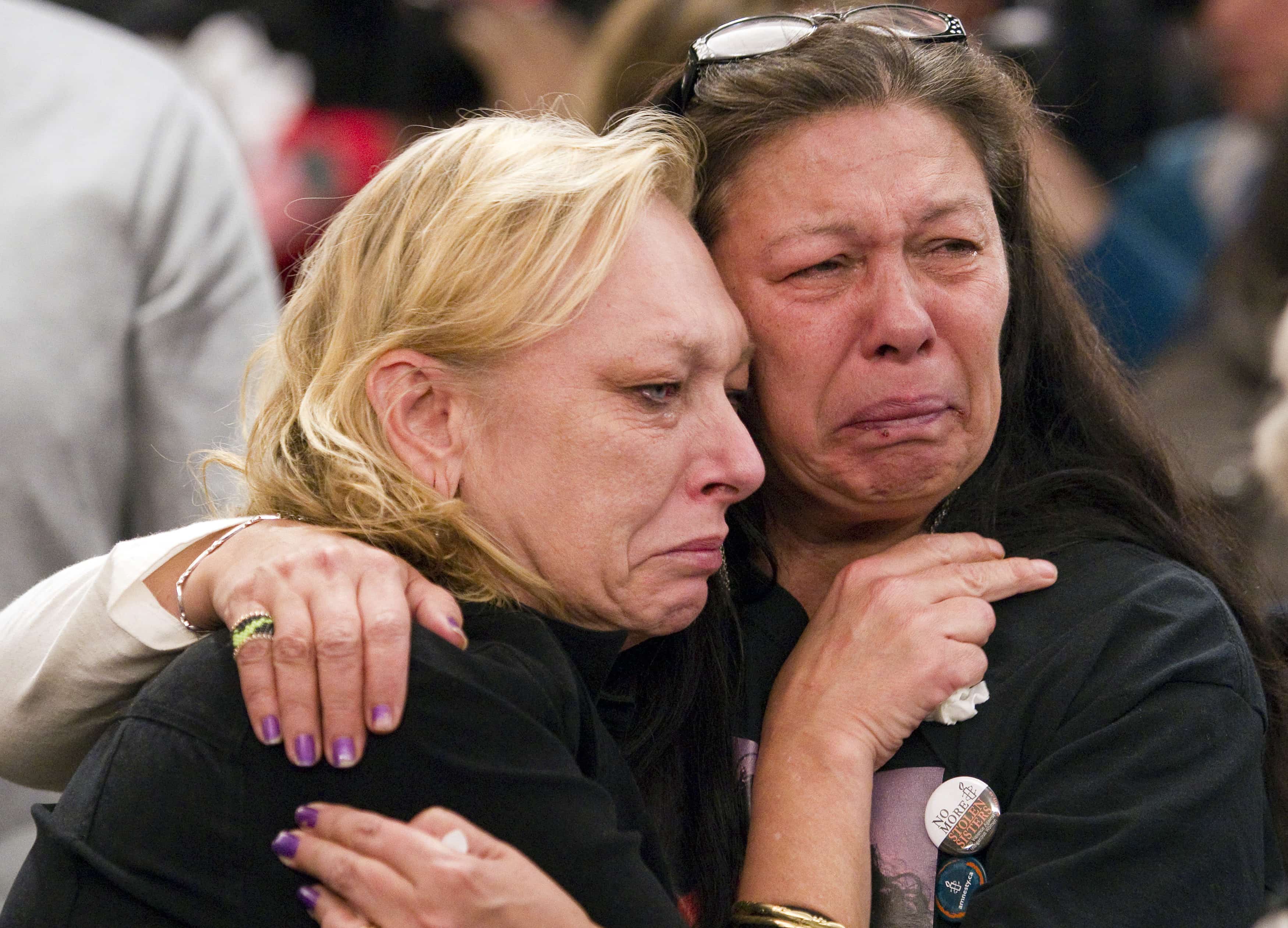 Mothers of daughters, who are part of British Columbia's Missing Women's Inquiry, cry during Commissioner Wally Oppal's remarks in December 2012. , REUTERS/Ben Nelms