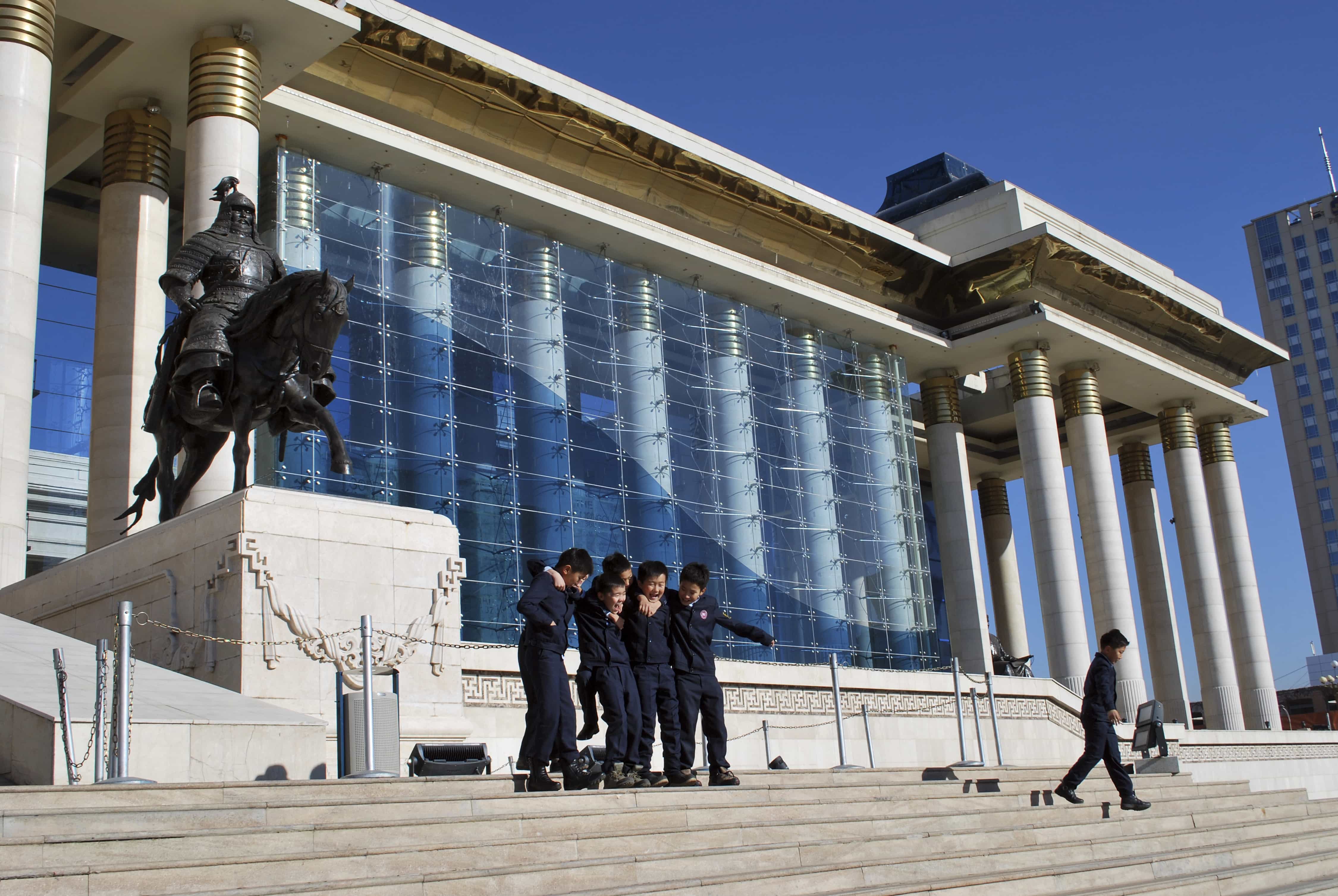 In this 30 October 2015 file photo, children play in front of the Mongolian Parliament House in Ulaanbaatar, AP Photo/Ganbat Namjilsangarav, File