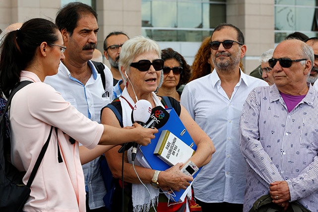 Nadire Mater (3rd L), accompanied by her fellow journalists and guest editors of Özgür Gündem, Faruk Balikci (2nd L), Yildirim Turker (2nd R) and Tugrul Eryilmaz (R). Outside the Justice Palace in Istanbul, Turkey, June 27, 2016., Reuters