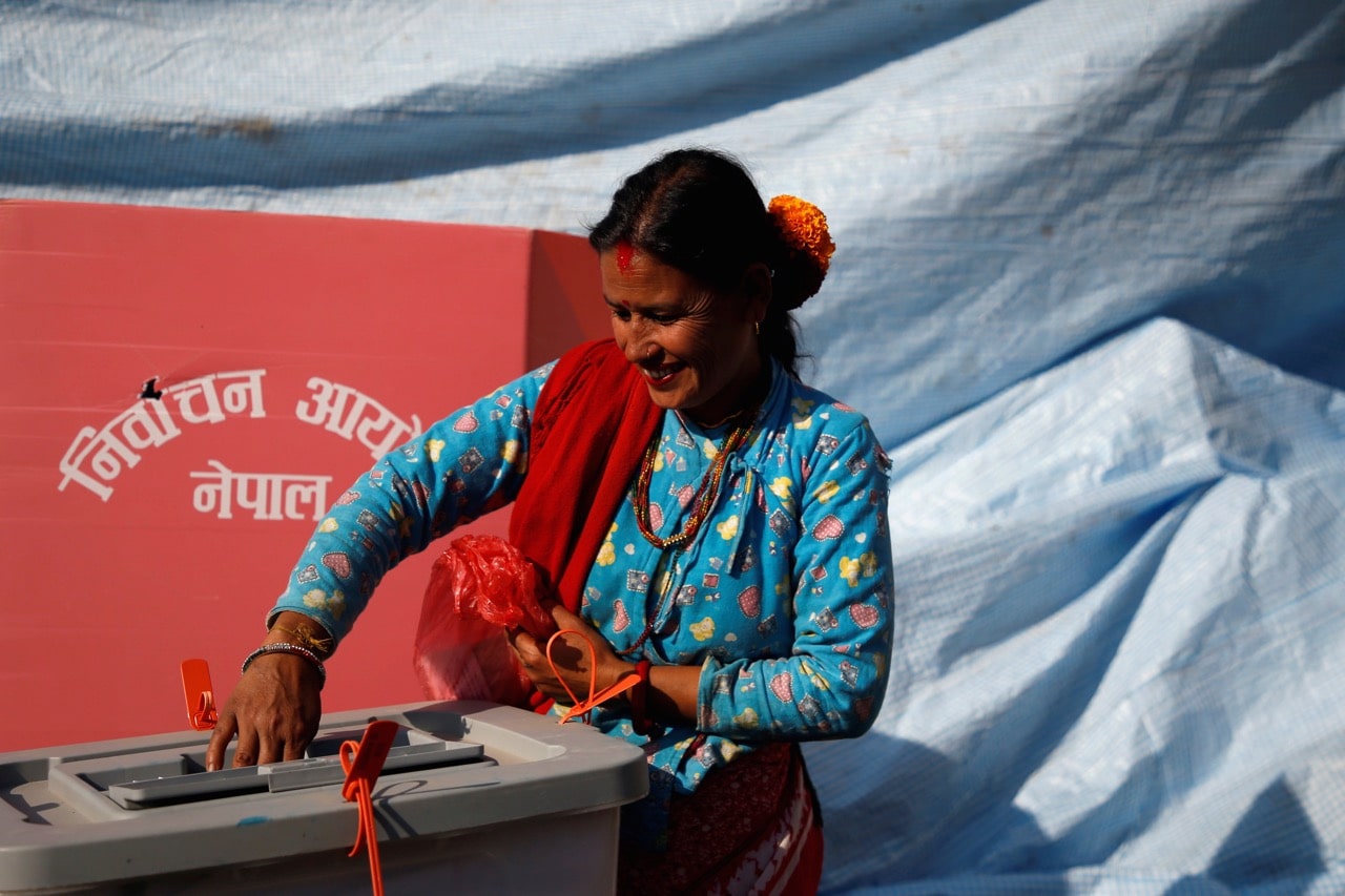 A woman casts her vote on a ballot box during the parliamentary and provincial elections in Sindhupalchok District, Nepal, 26 November 2017, REUTERS/Navesh Chitrakar