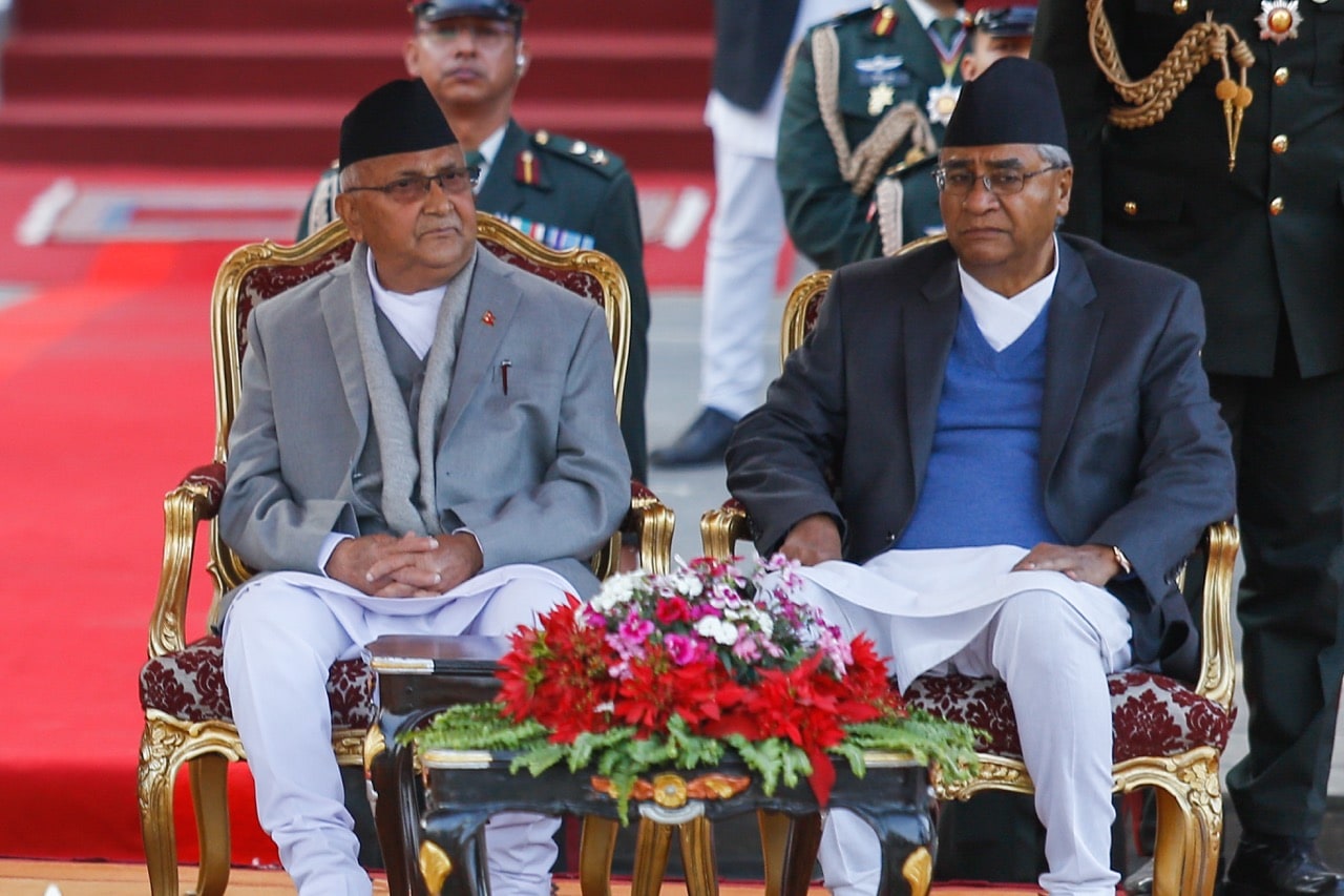 Nepal's new Prime Minister Khadga Prasad Oli (L) and outgoing Prime Minister Sher Bahadur Deuba (R) during the swearing-in ceremony at the presidential building in Kathmandu, 15 February 2018, Sunil Pradhan/Anadolu Agency/Getty Images