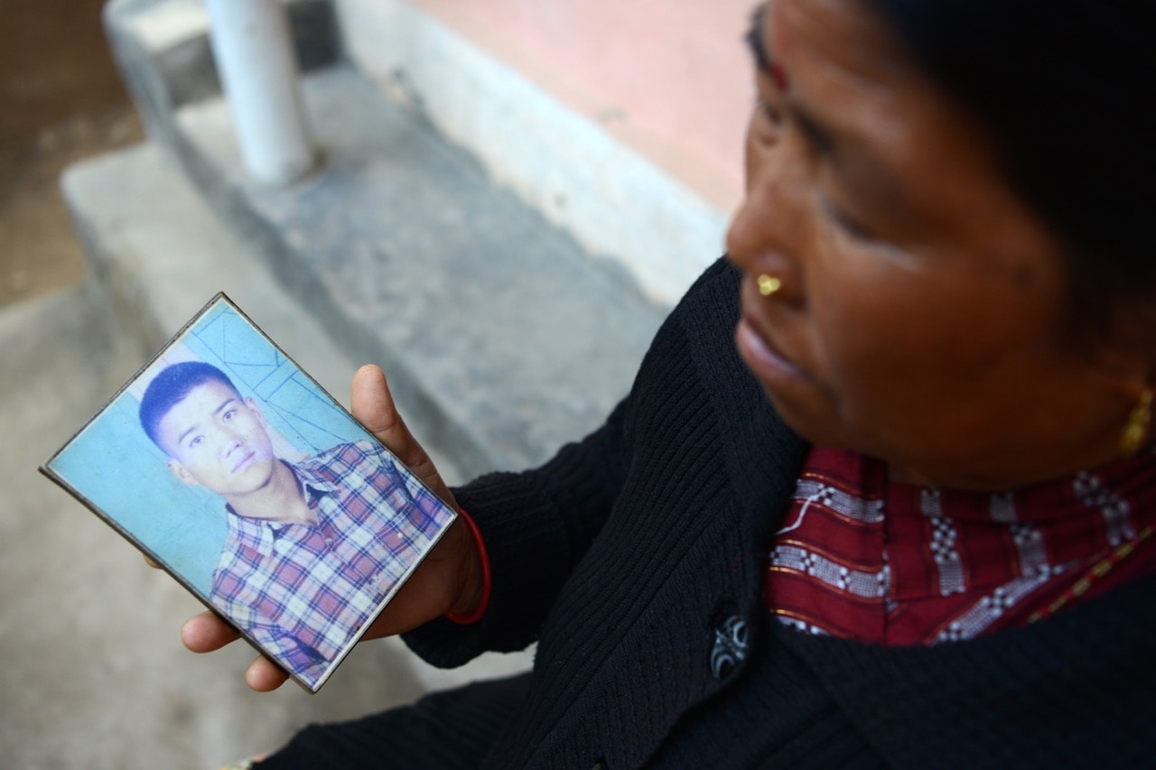 Nepalese war victim Pabitra Sunakhari shows a photograph of her son as she speaks during an interview with AFP in Surkhet District, 2 February 2017, PRAKASH MATHEMA/AFP/Getty Images