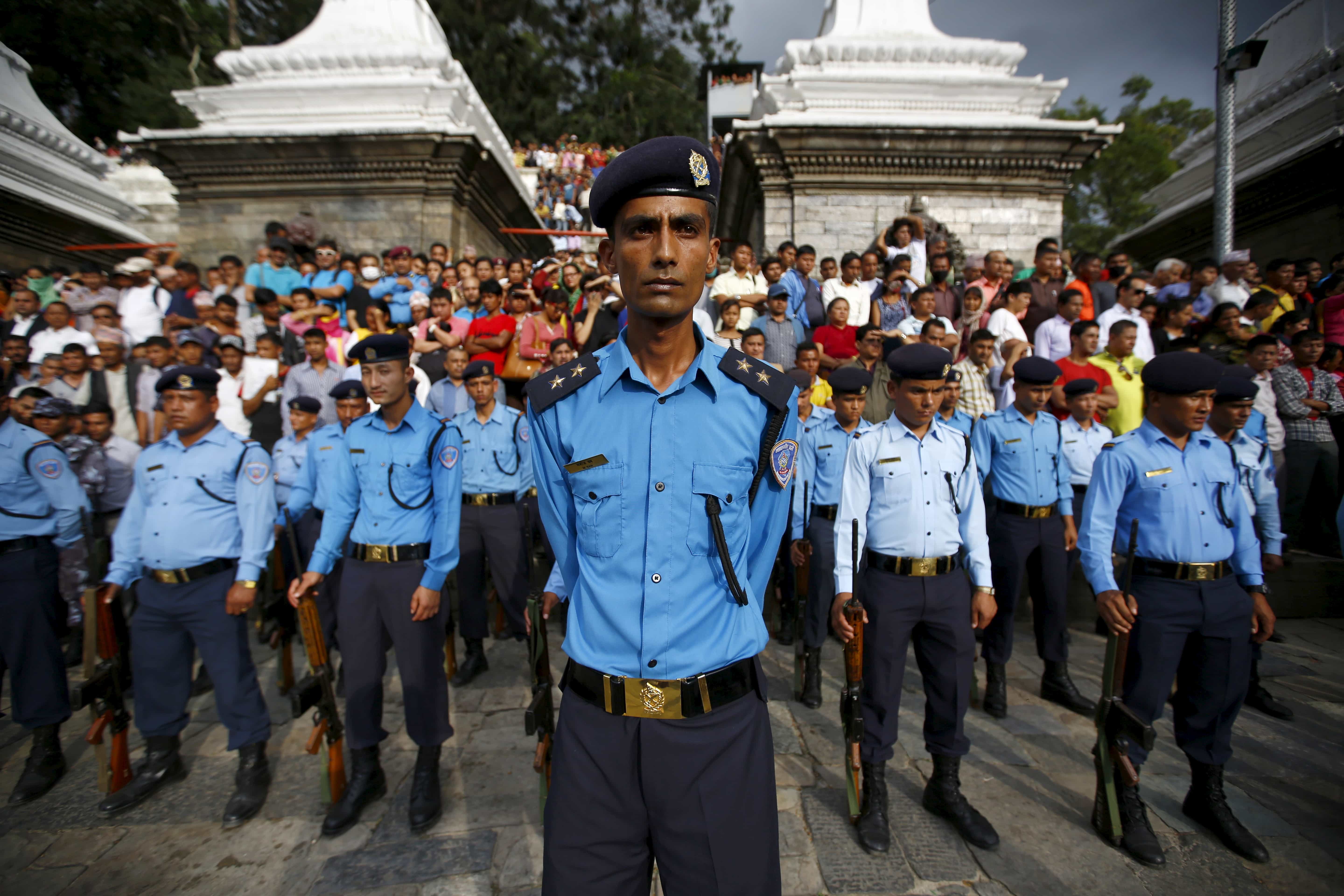 Nepali police stand during a cremation ceremony of Senior Superintendent of Police (SSP) Laxman Neupane, who was killed in Monday's protest at Tikapur in Kailali district, in Kathmandu, 25 August 2015, REUTERS/Navesh Chitrakar